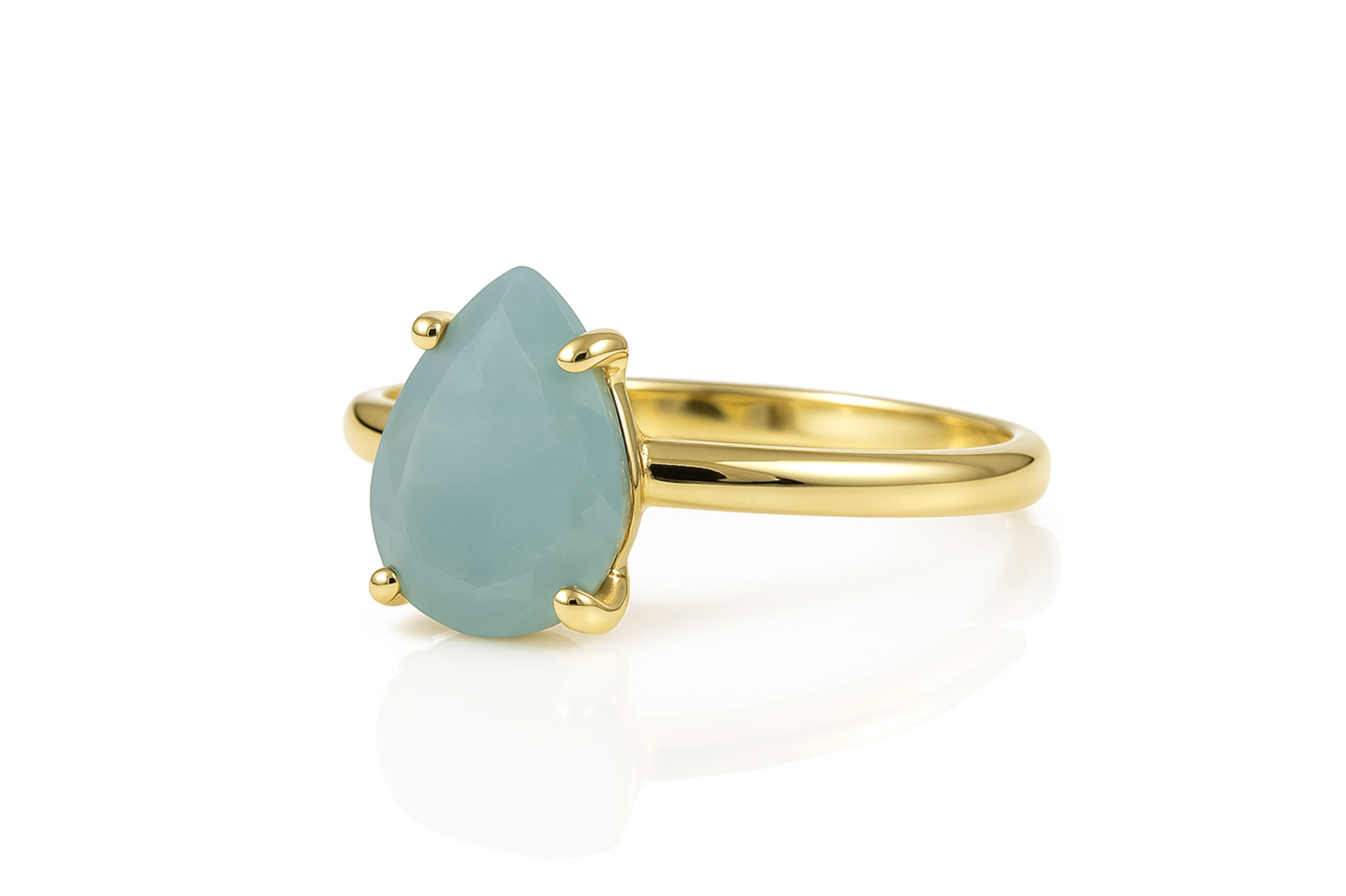 a yellow gold ring with a blue stone