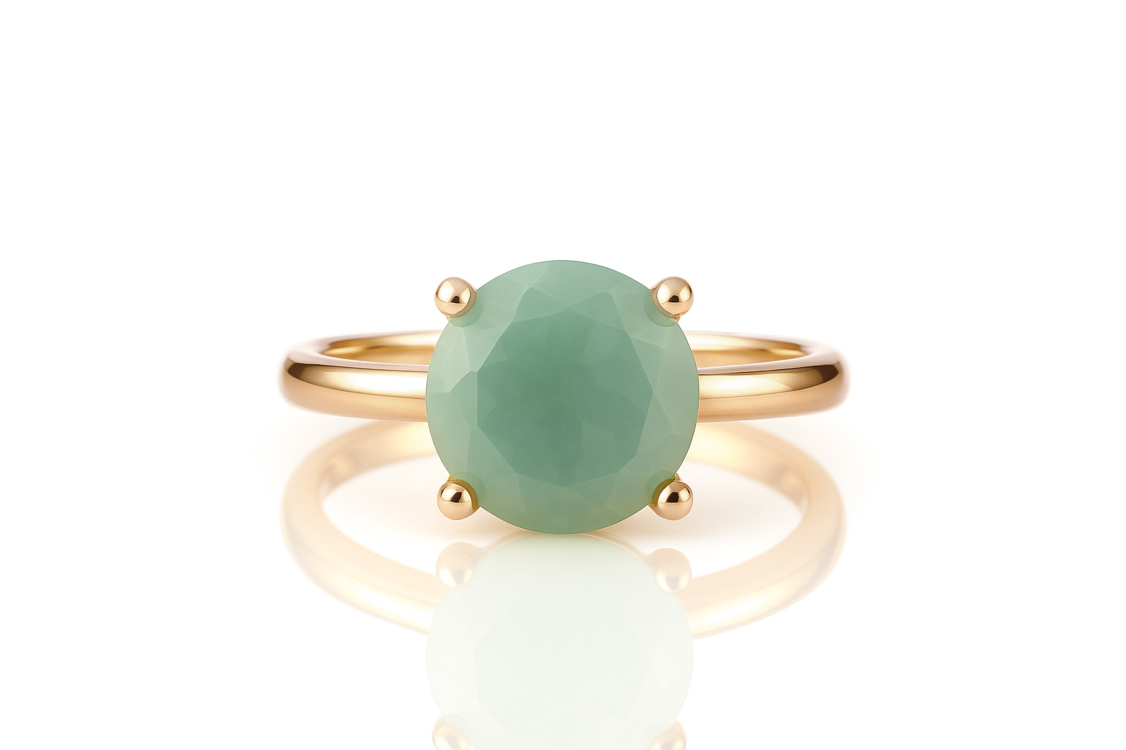 a gold ring with a green stone on it