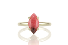 a close up of a ring with a red stone
