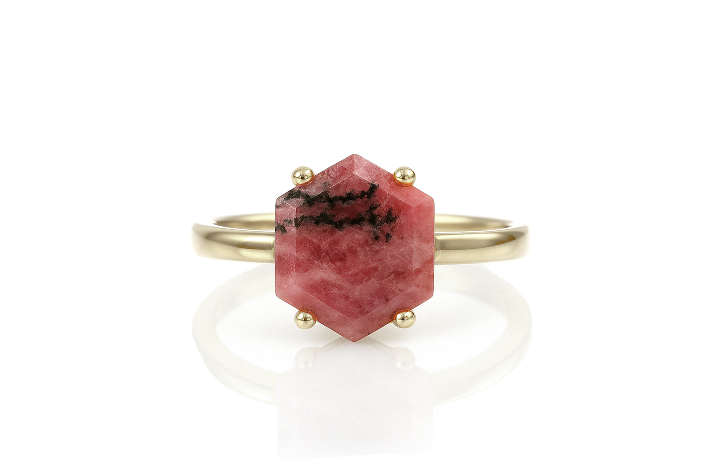 a gold ring with a red stone on it