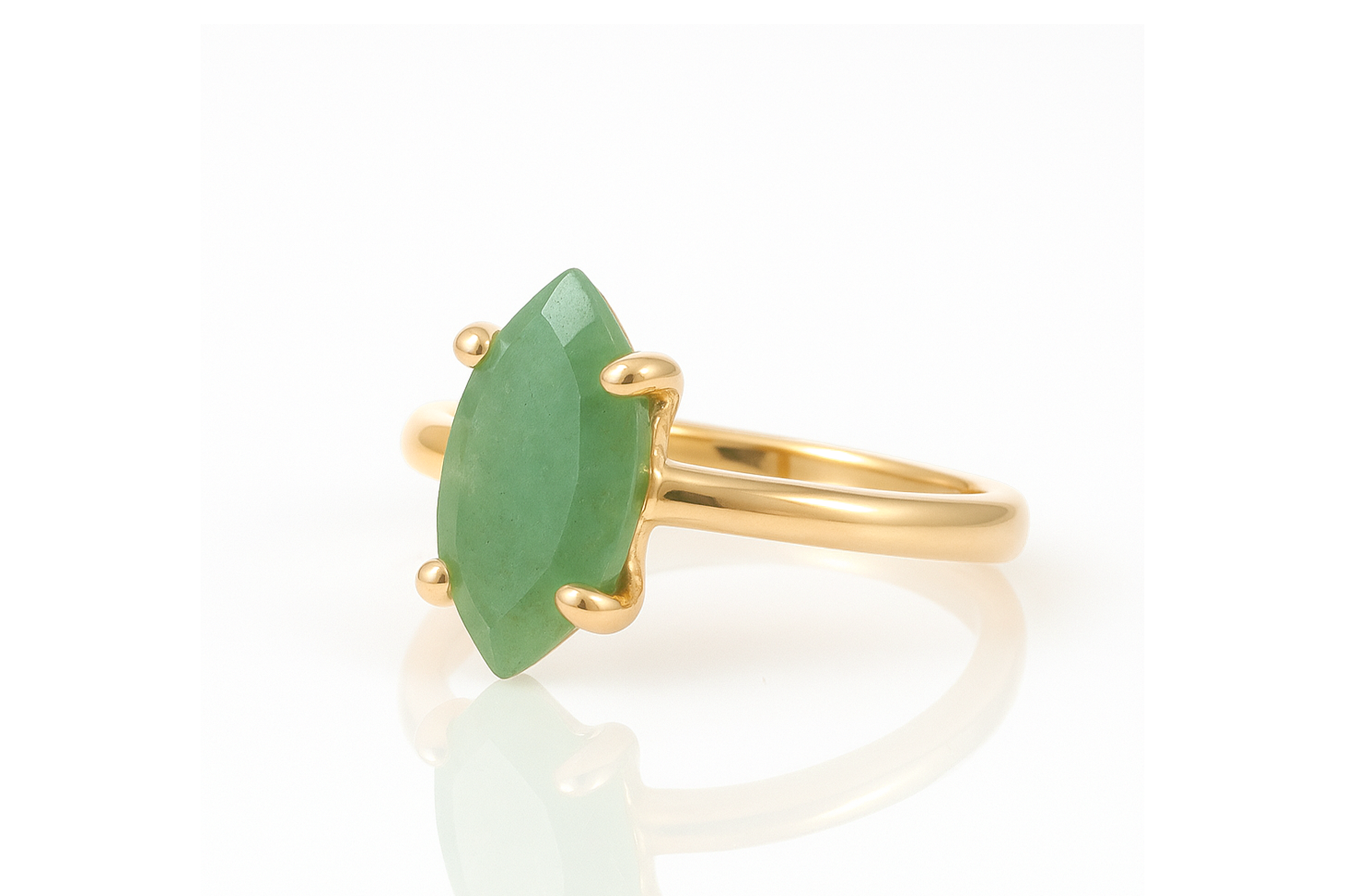 a gold ring with a green stone on it