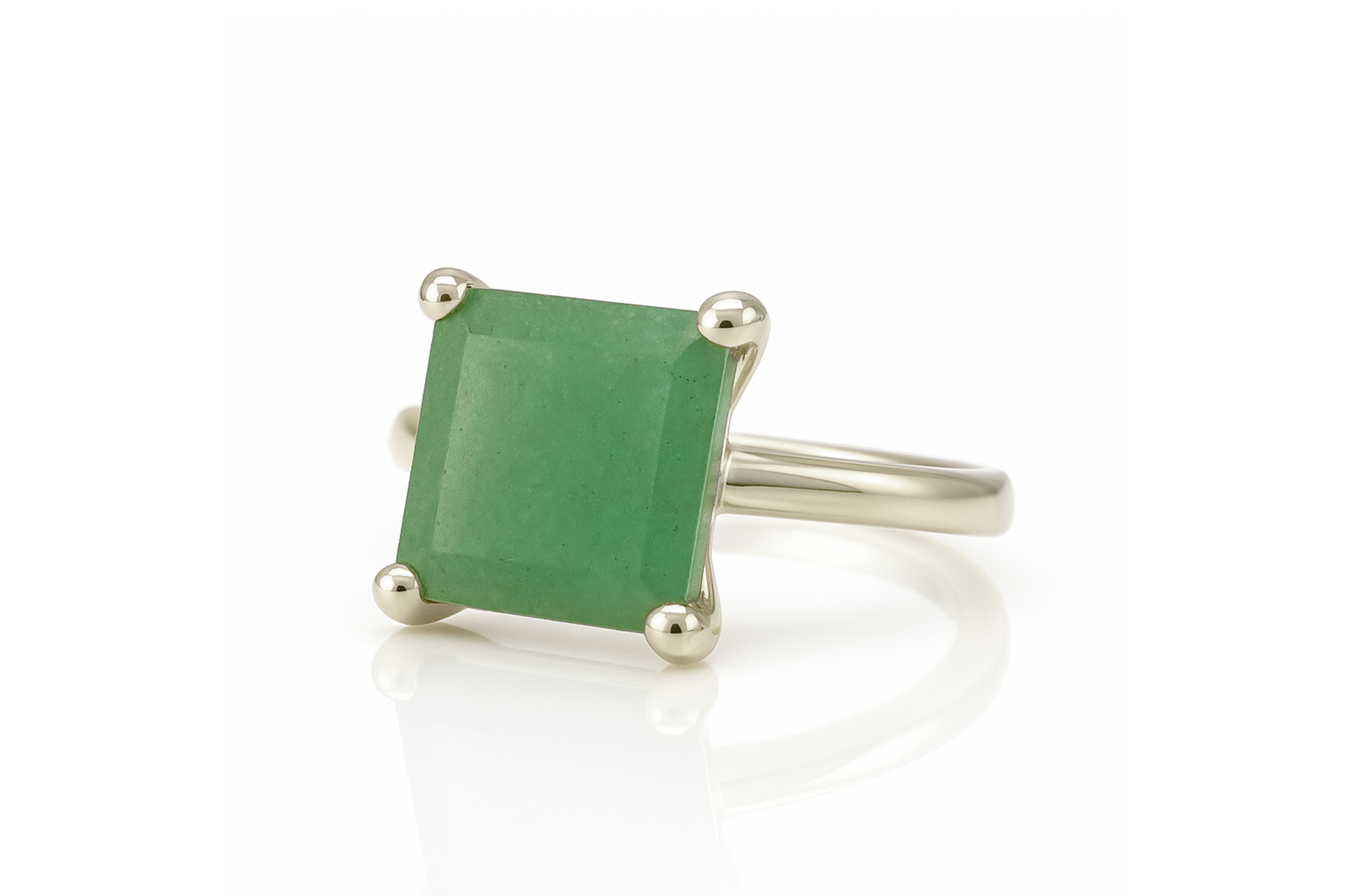 a ring with a green stone in it