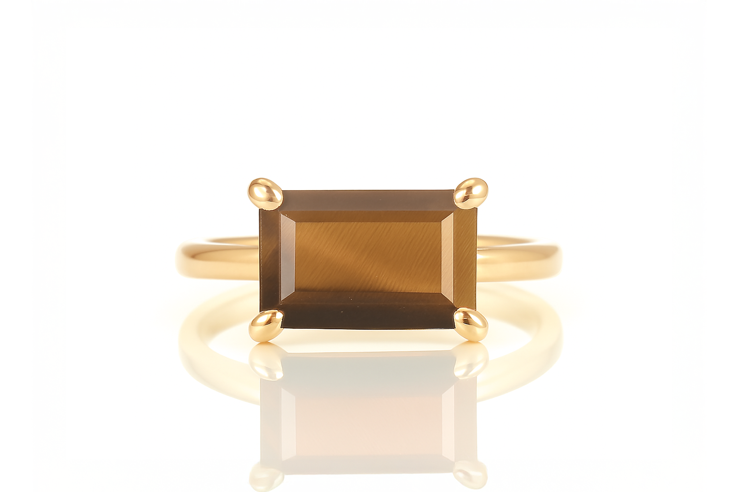 a gold ring with a large brown stone