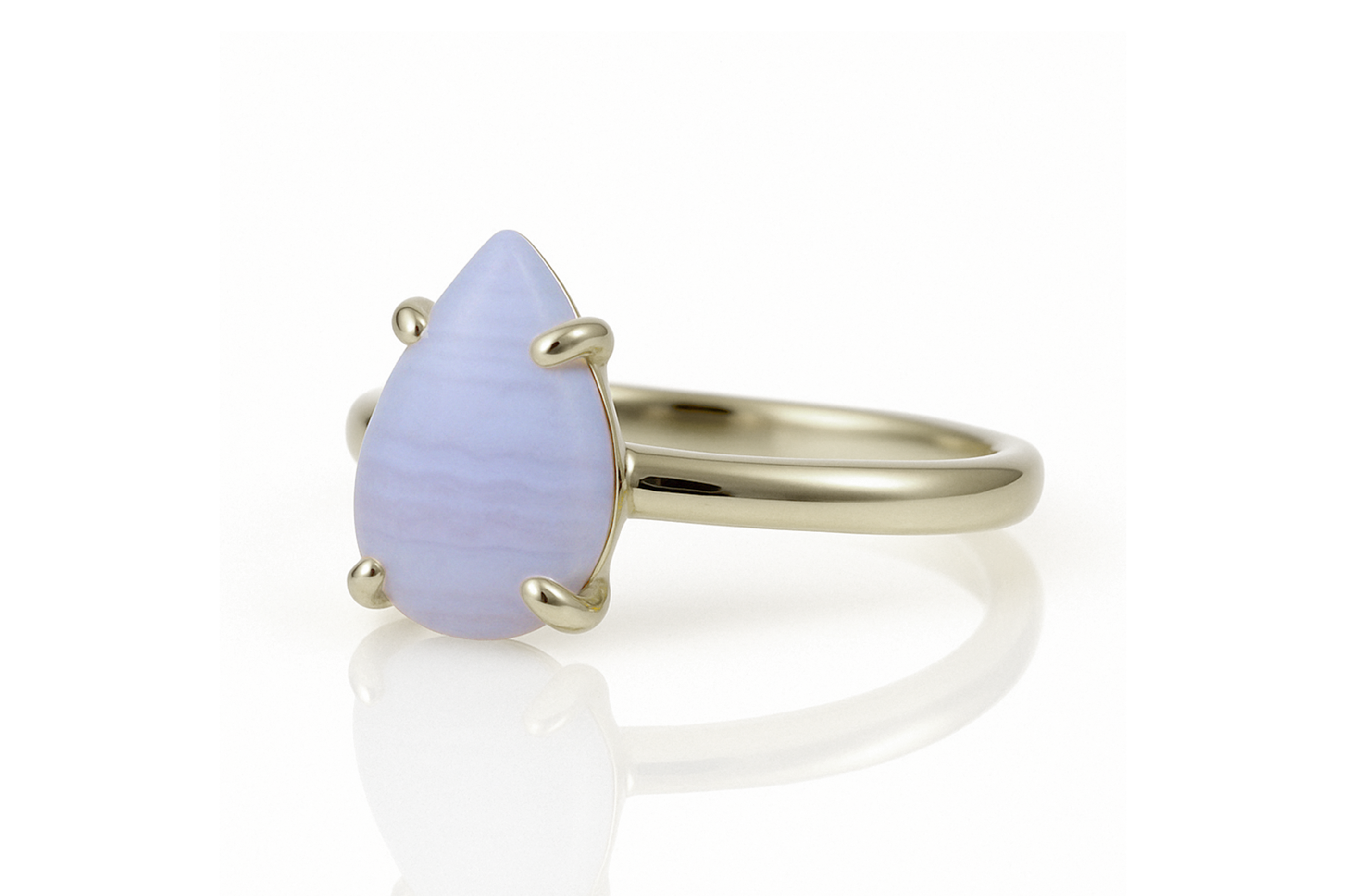 a yellow gold ring with a blue stone