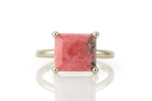 a ring with a pink stone on top of it