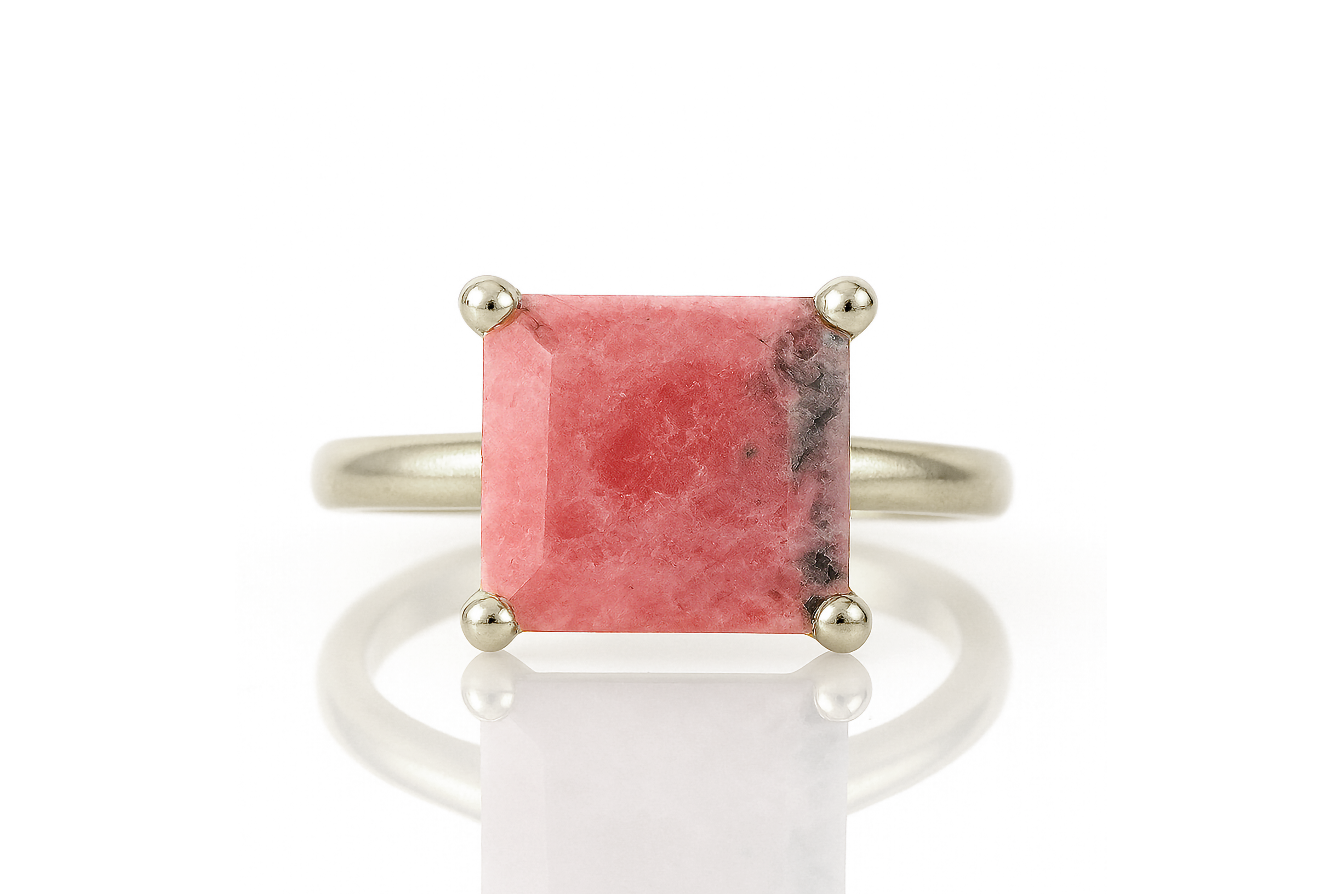 a ring with a pink stone on top of it