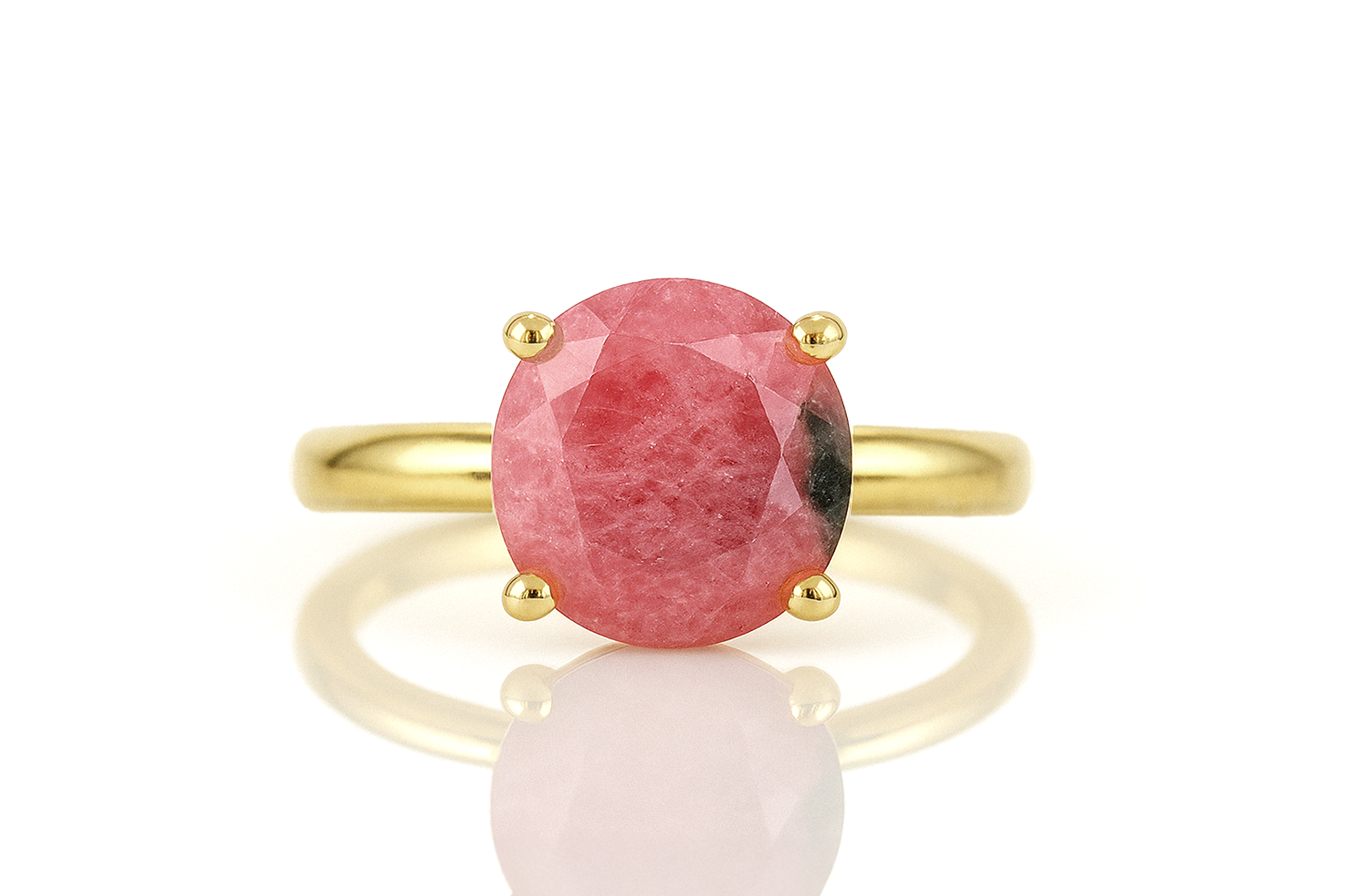 a close up of a ring with a pink stone