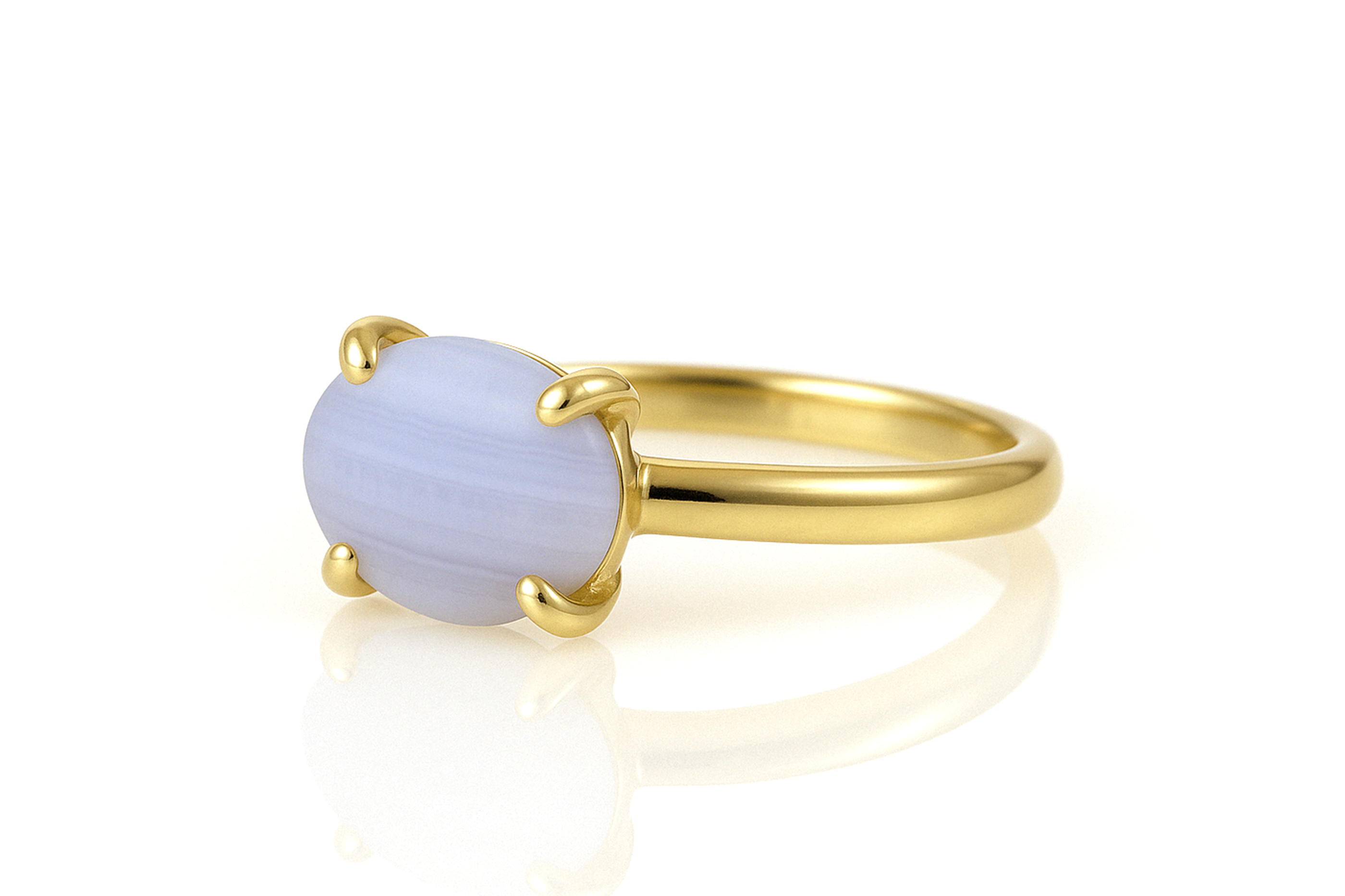 a yellow gold ring with a blue stone