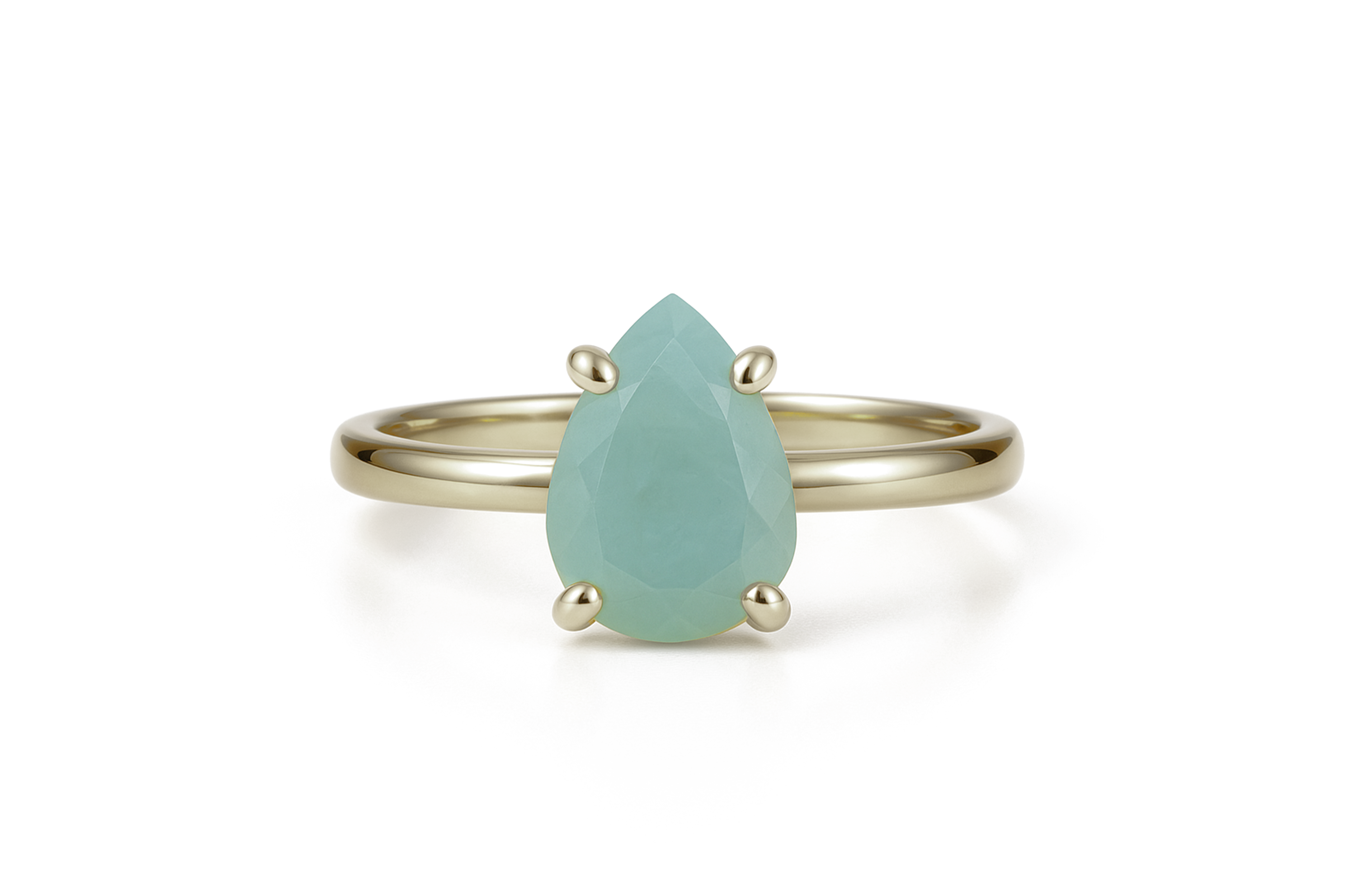 a gold ring with a pear shaped green stone