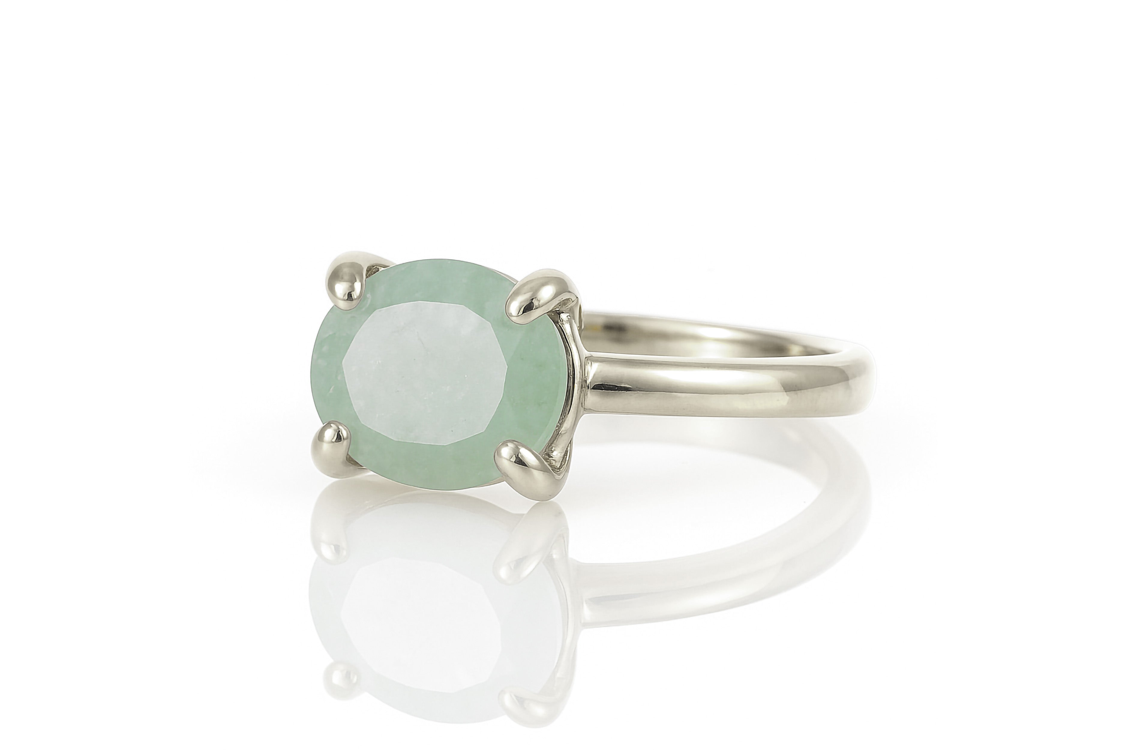 a ring with a green stone on it