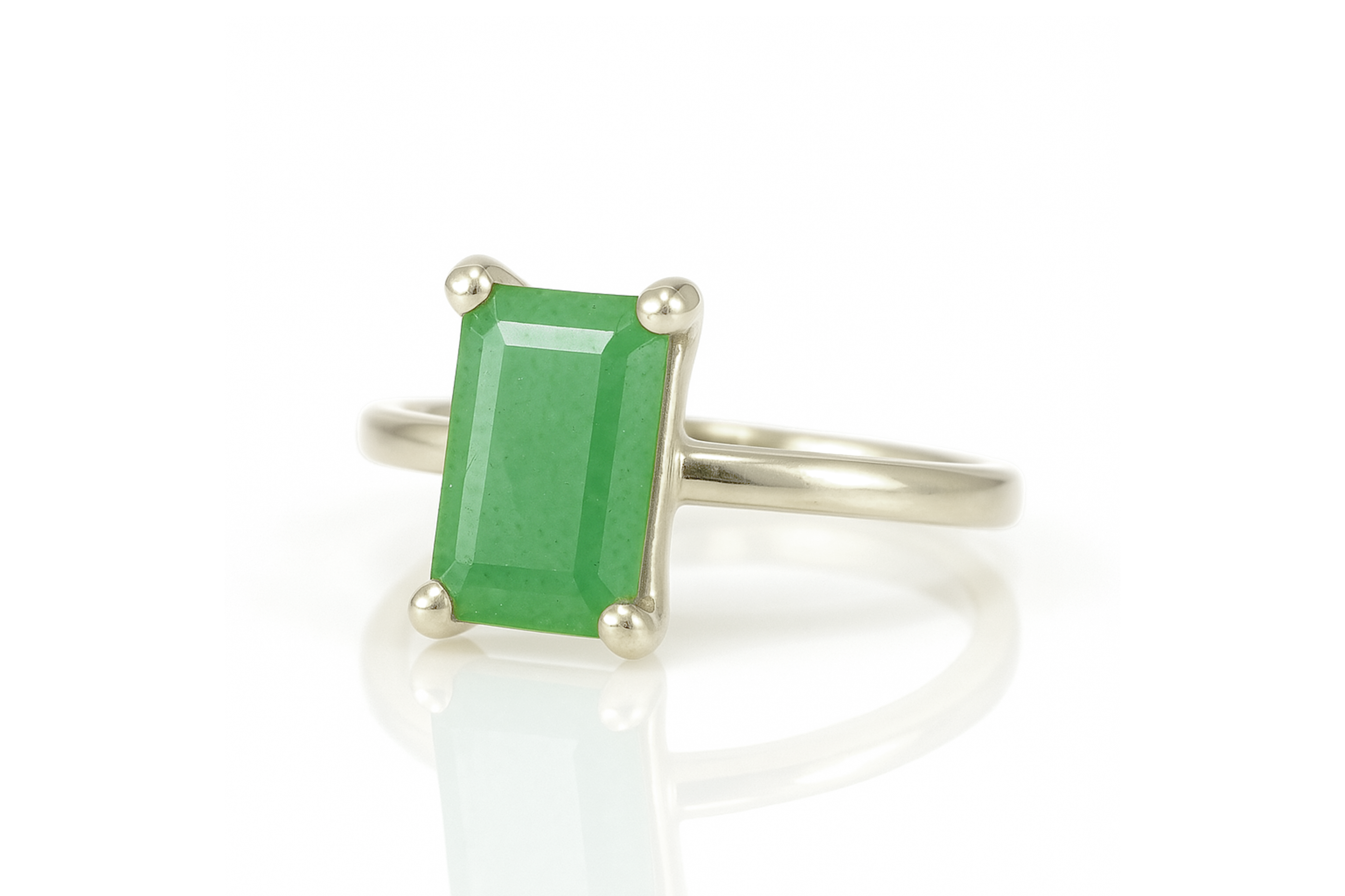 a ring with a green stone on it