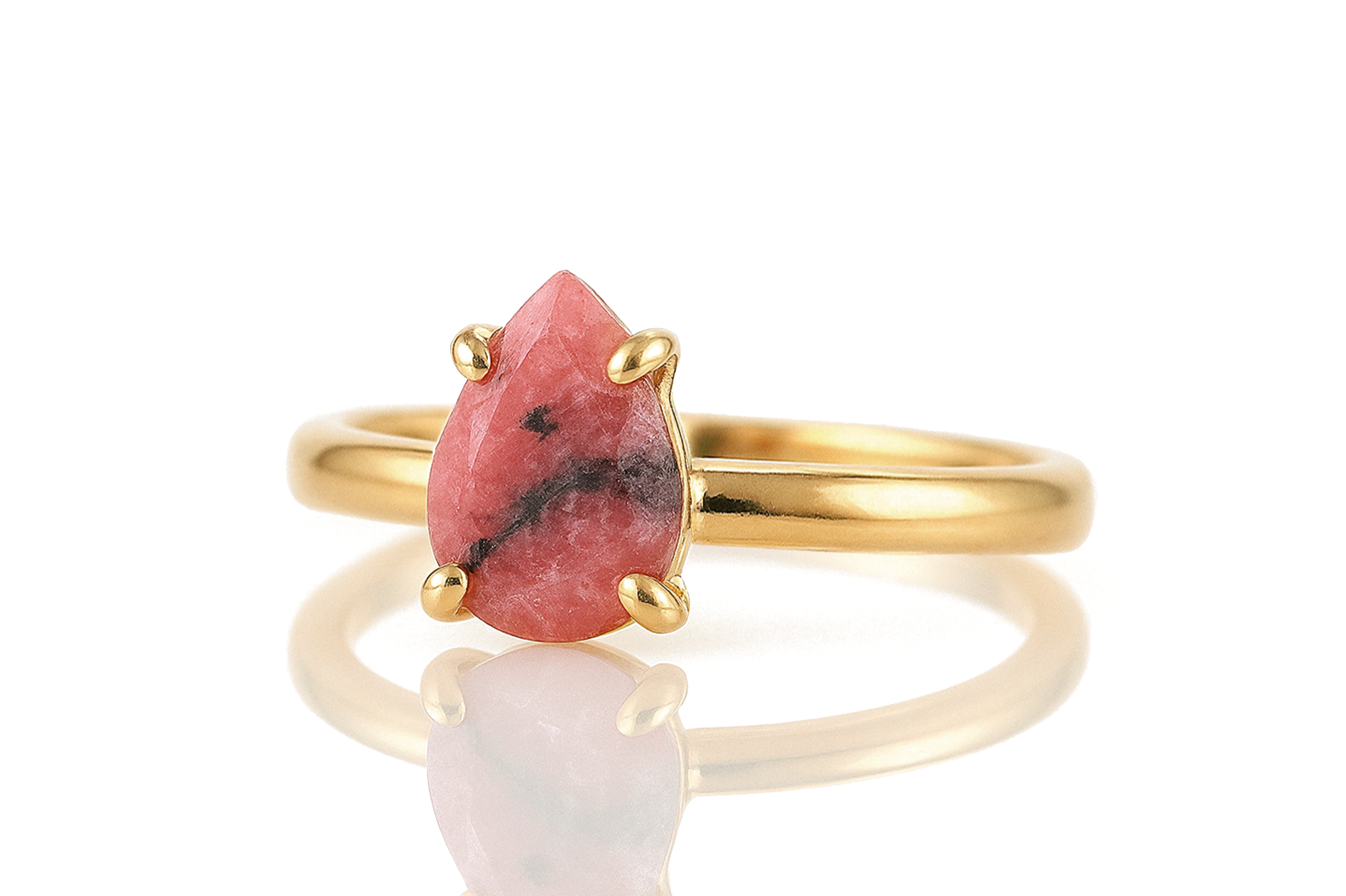 a gold ring with a pink stone on it