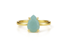 a gold ring with a pear shaped green stone