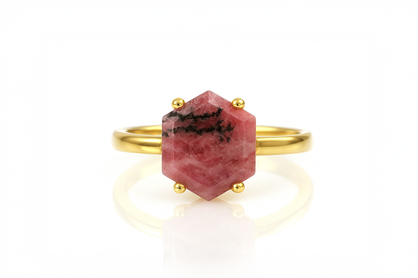 a gold ring with a red stone on it