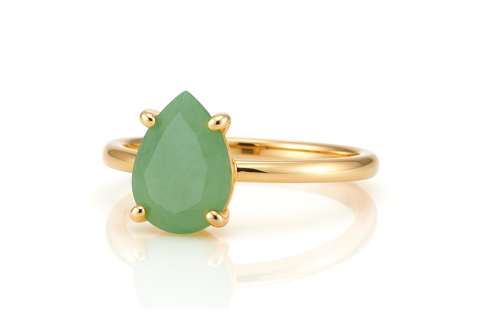 a gold ring with a pear shaped green stone
