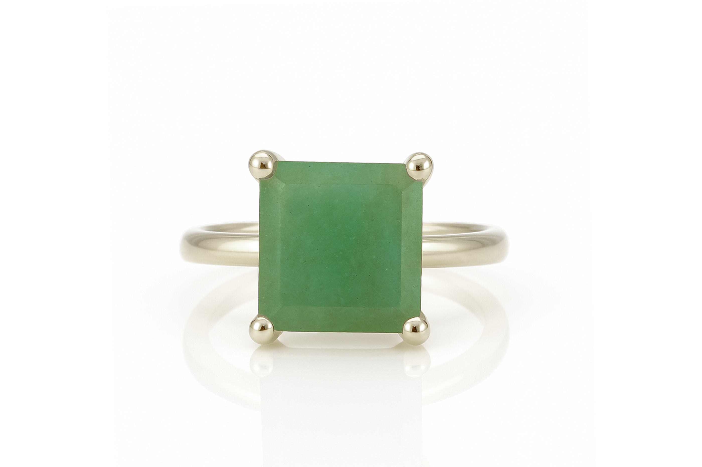 a ring with a green stone on it
