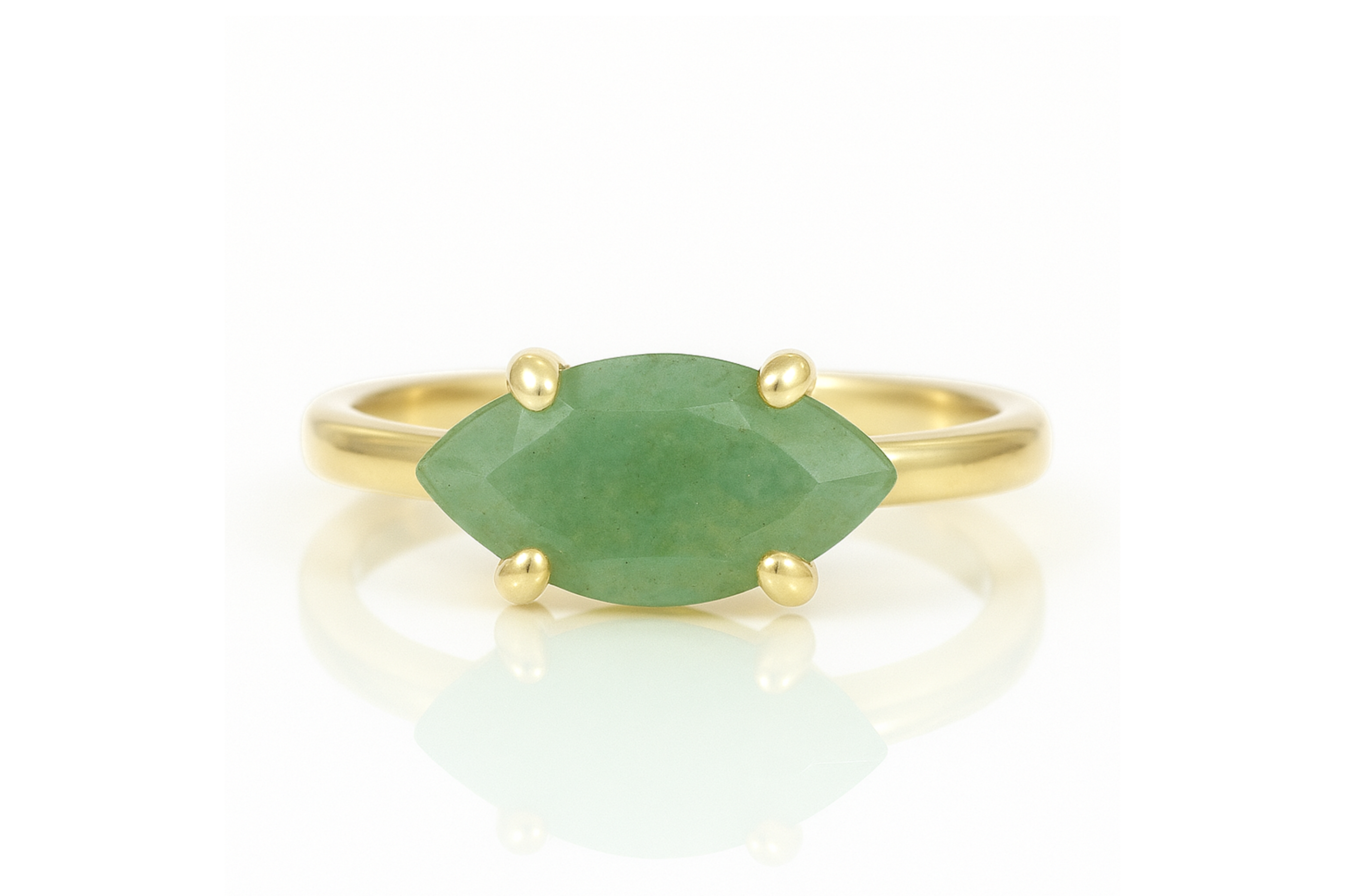 a gold ring with a green stone on it
