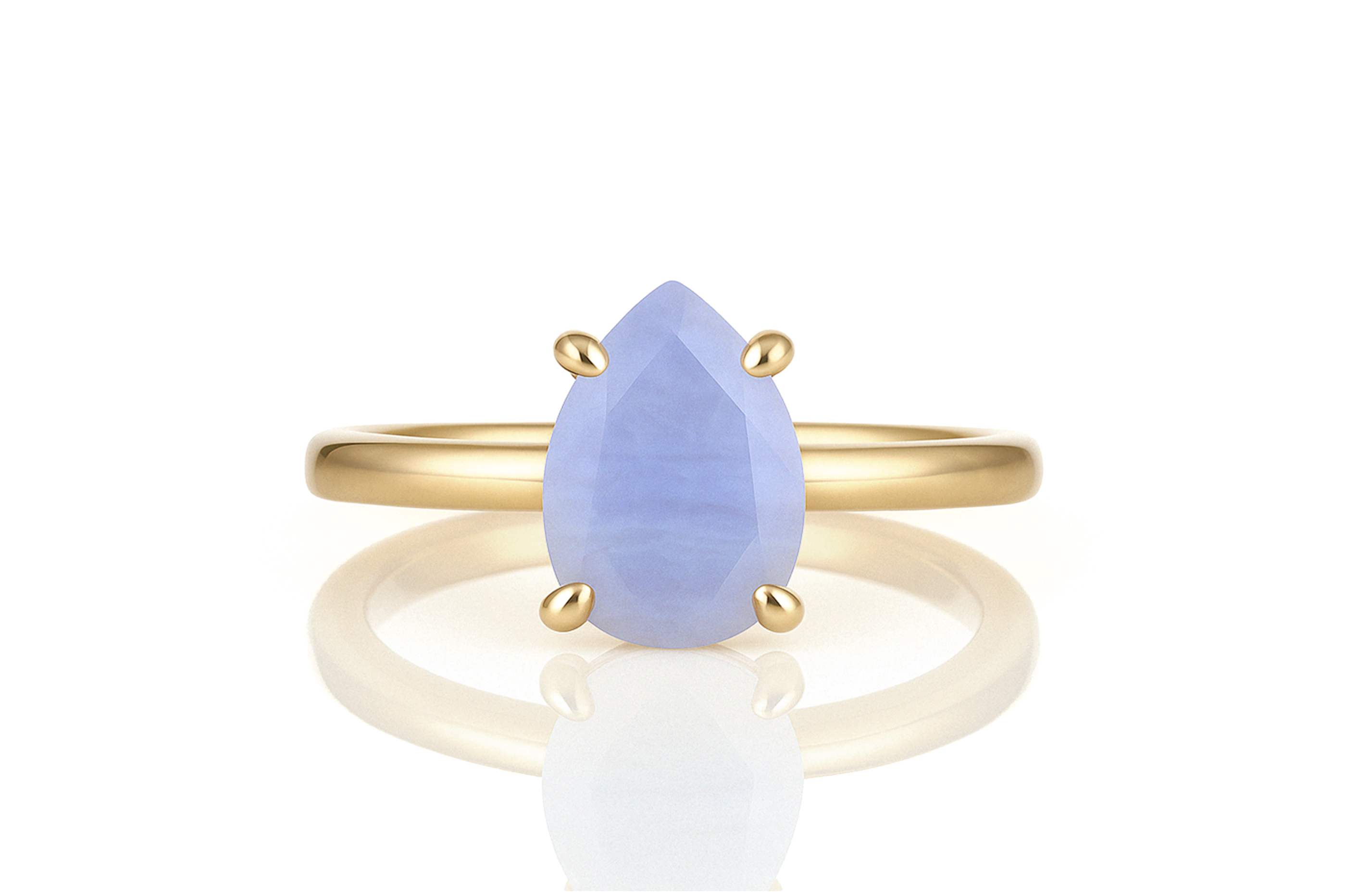 a yellow gold ring with a blue tear shaped stone