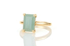 a gold ring with a green stone on it