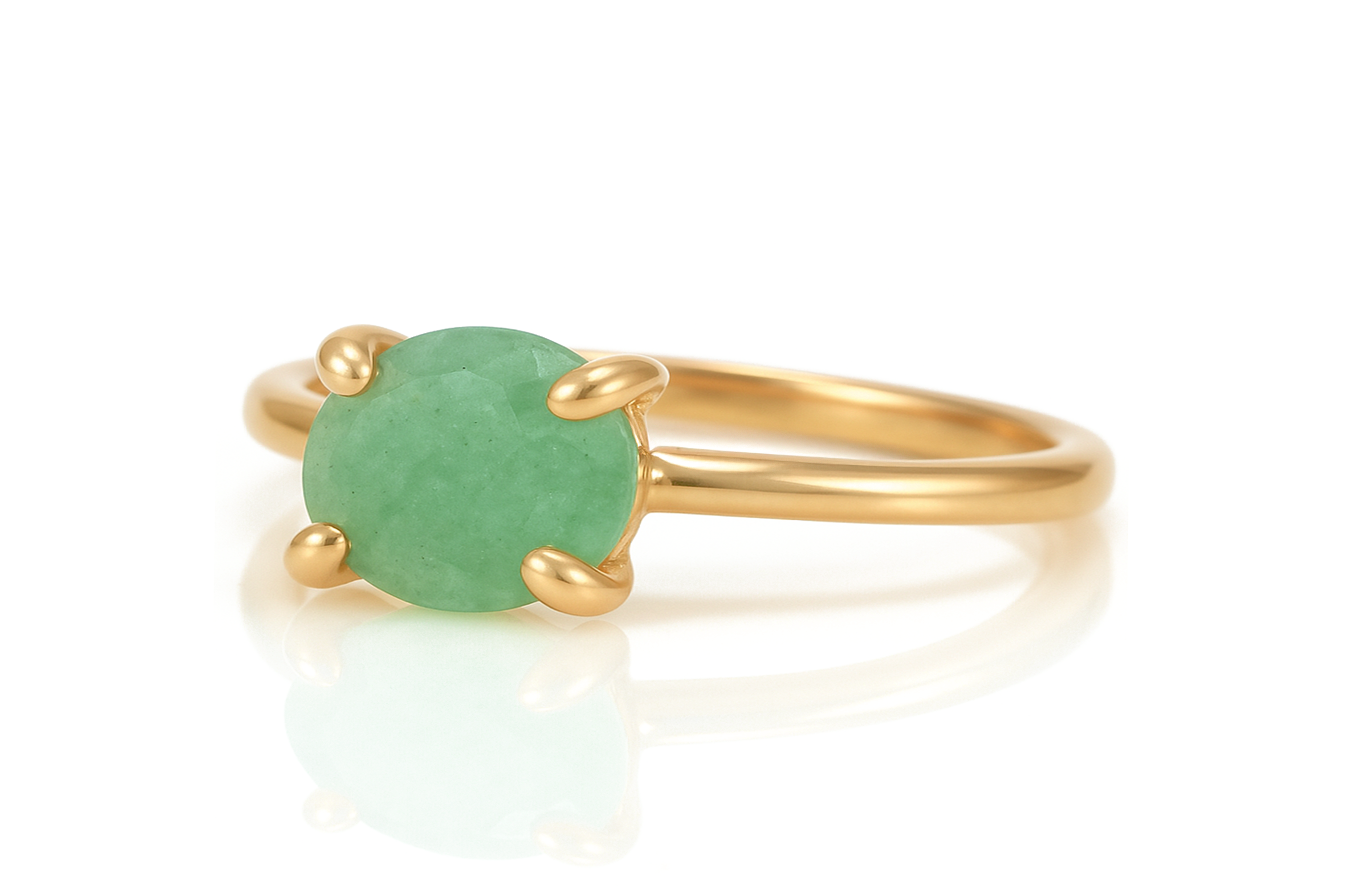 a gold ring with a green stone on it