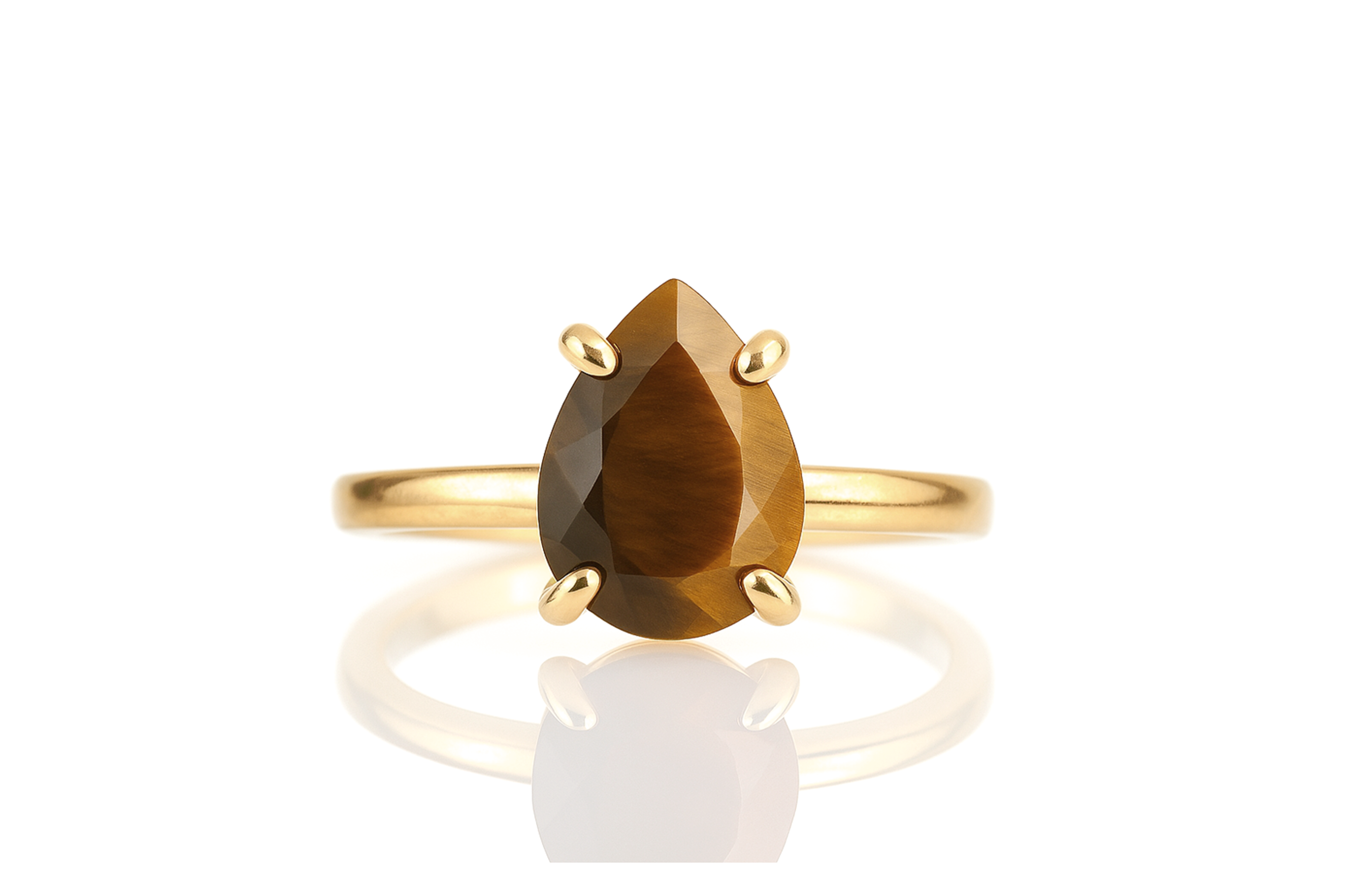a yellow gold ring with a pear shaped brown stone
