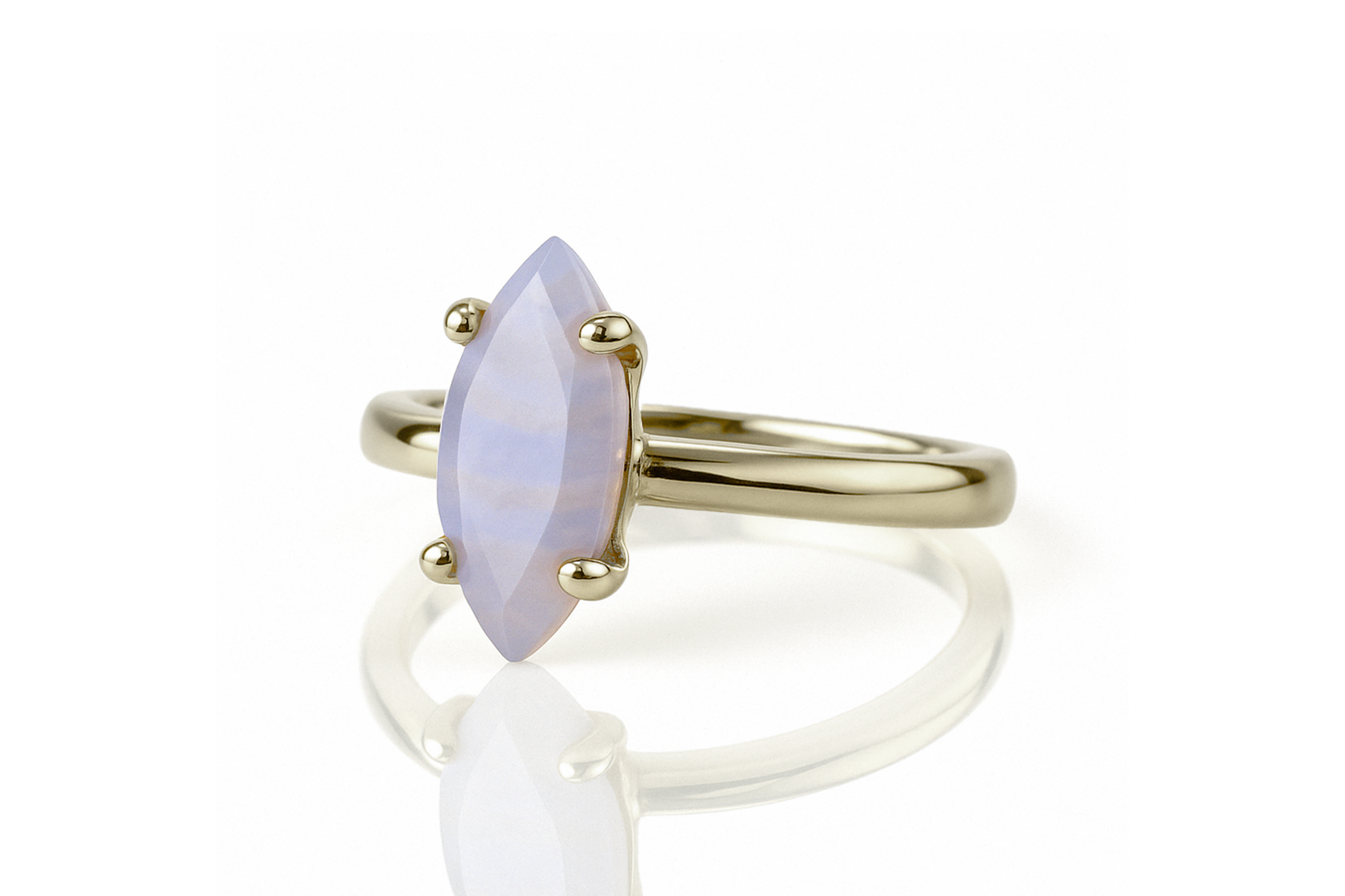 a yellow gold ring with a white stone