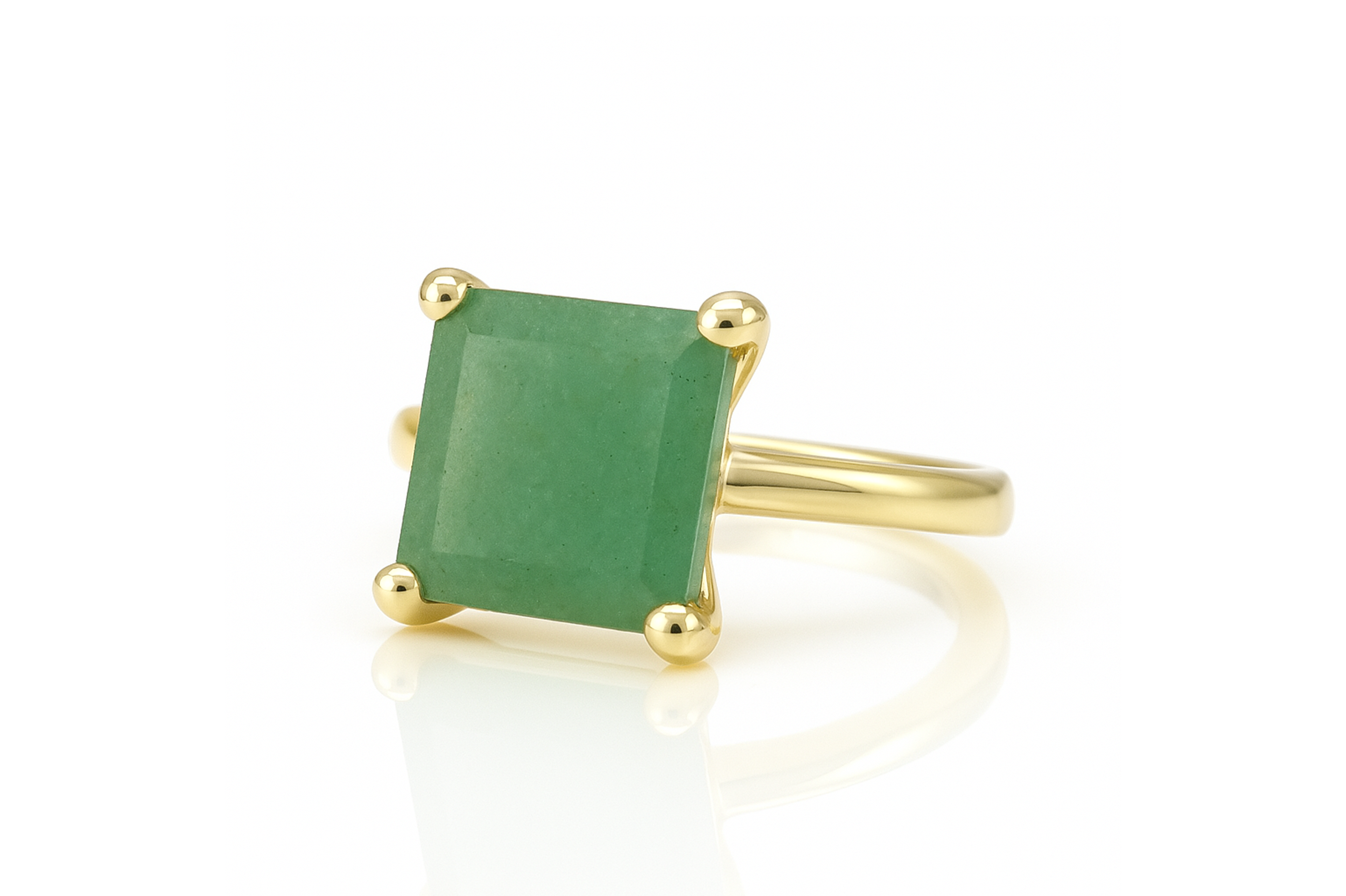 a gold ring with a green stone on it
