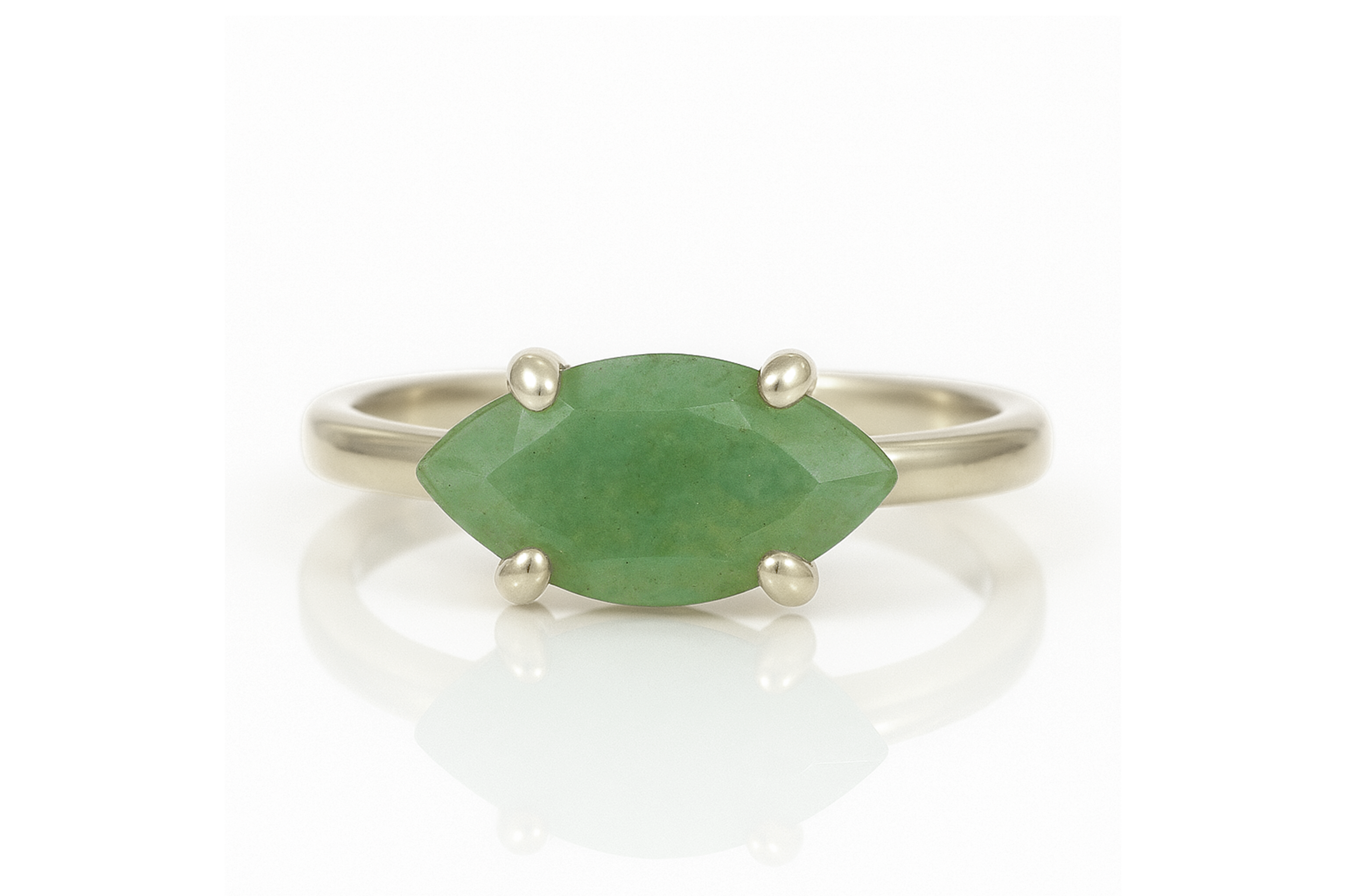 a close up of a ring with a green stone