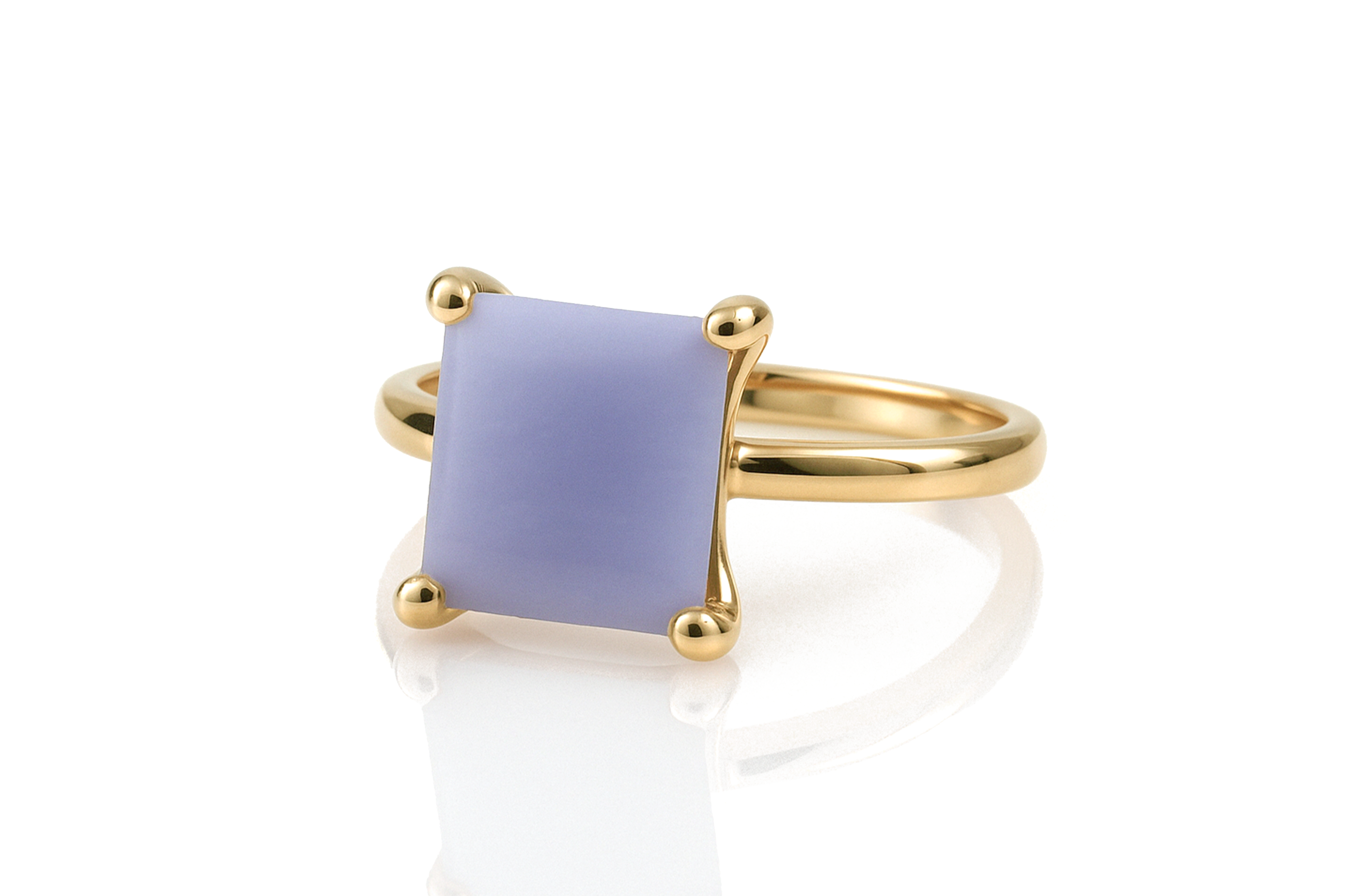 a yellow gold ring with a blue stone