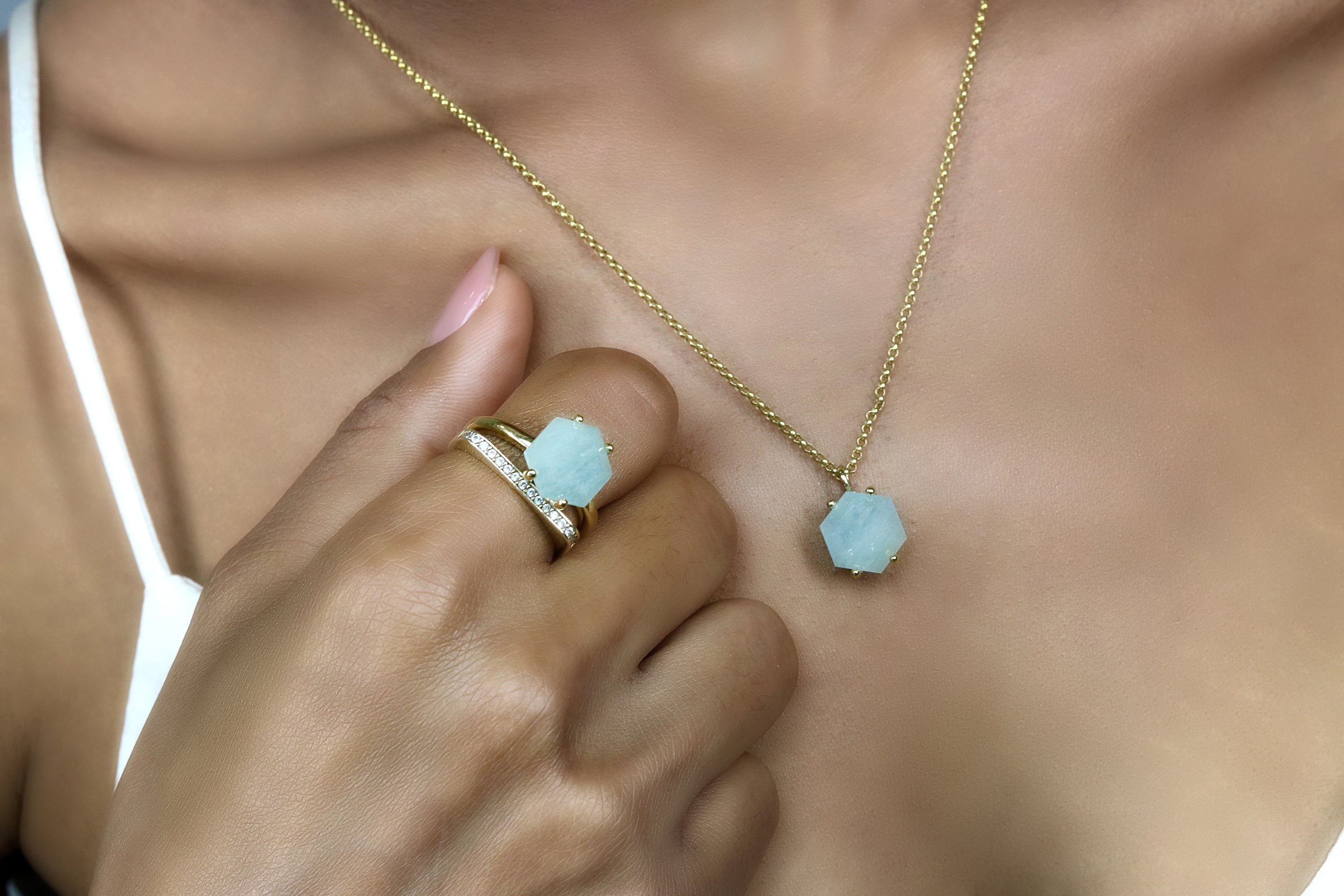 a woman wearing a ring and a necklace