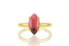 a yellow gold ring with a red stone