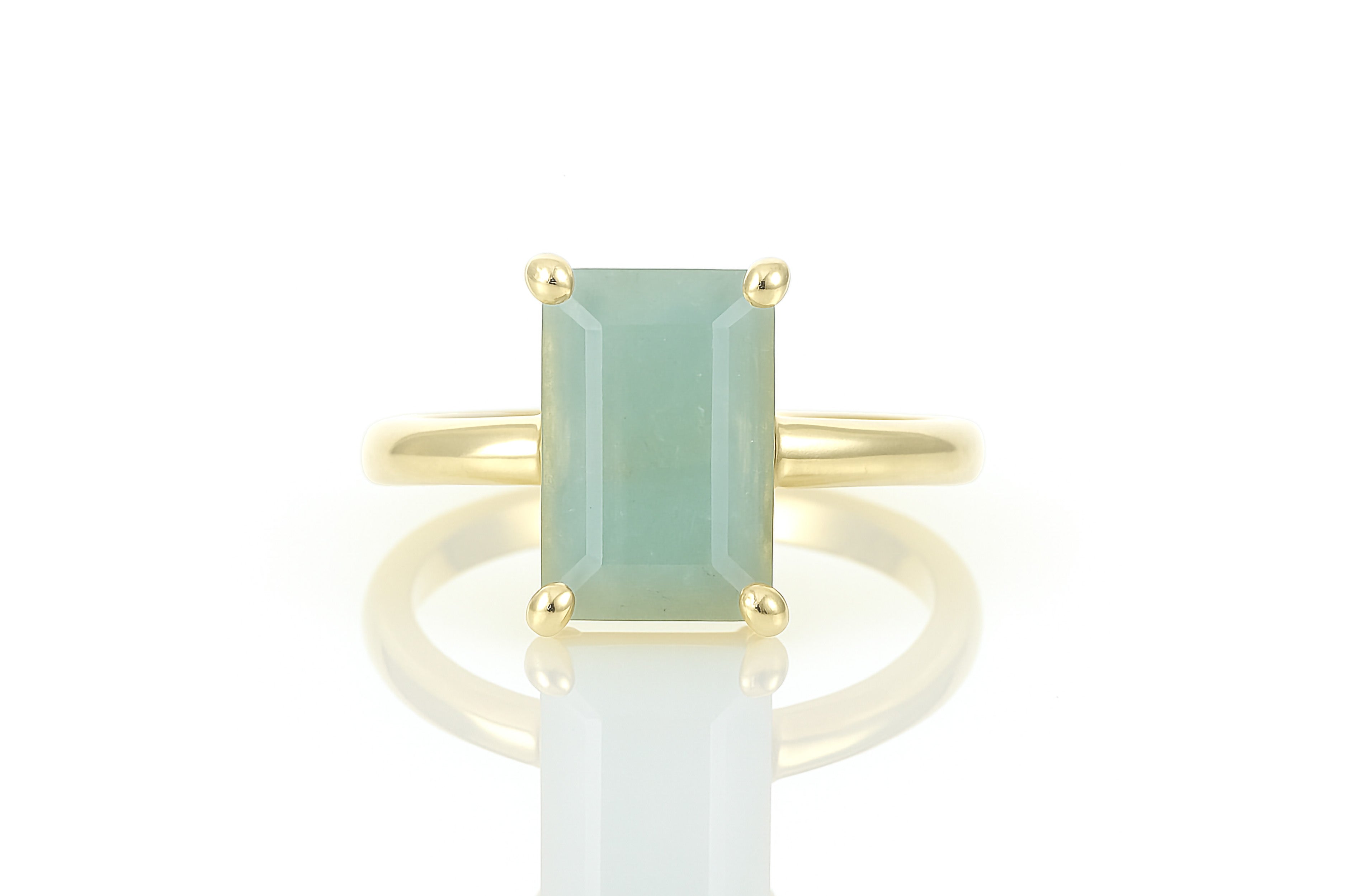 a ring with a green stone on top of it