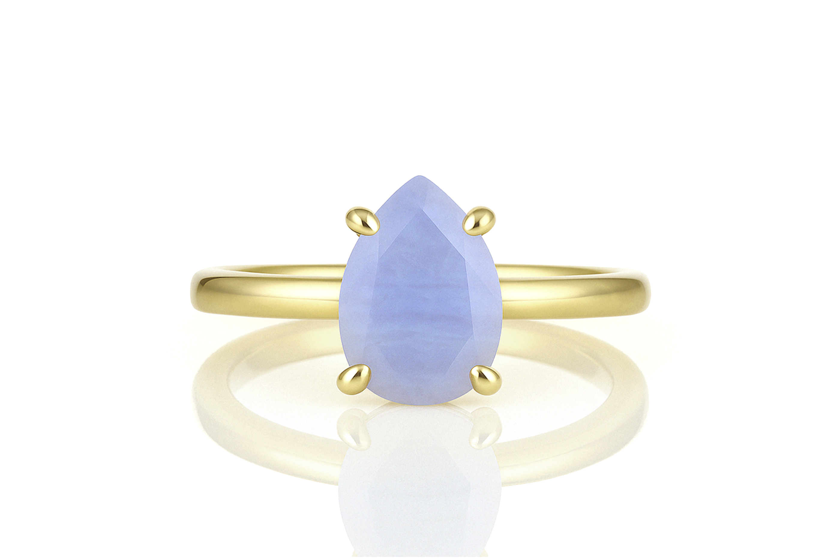 a yellow gold ring with a blue tear shaped stone