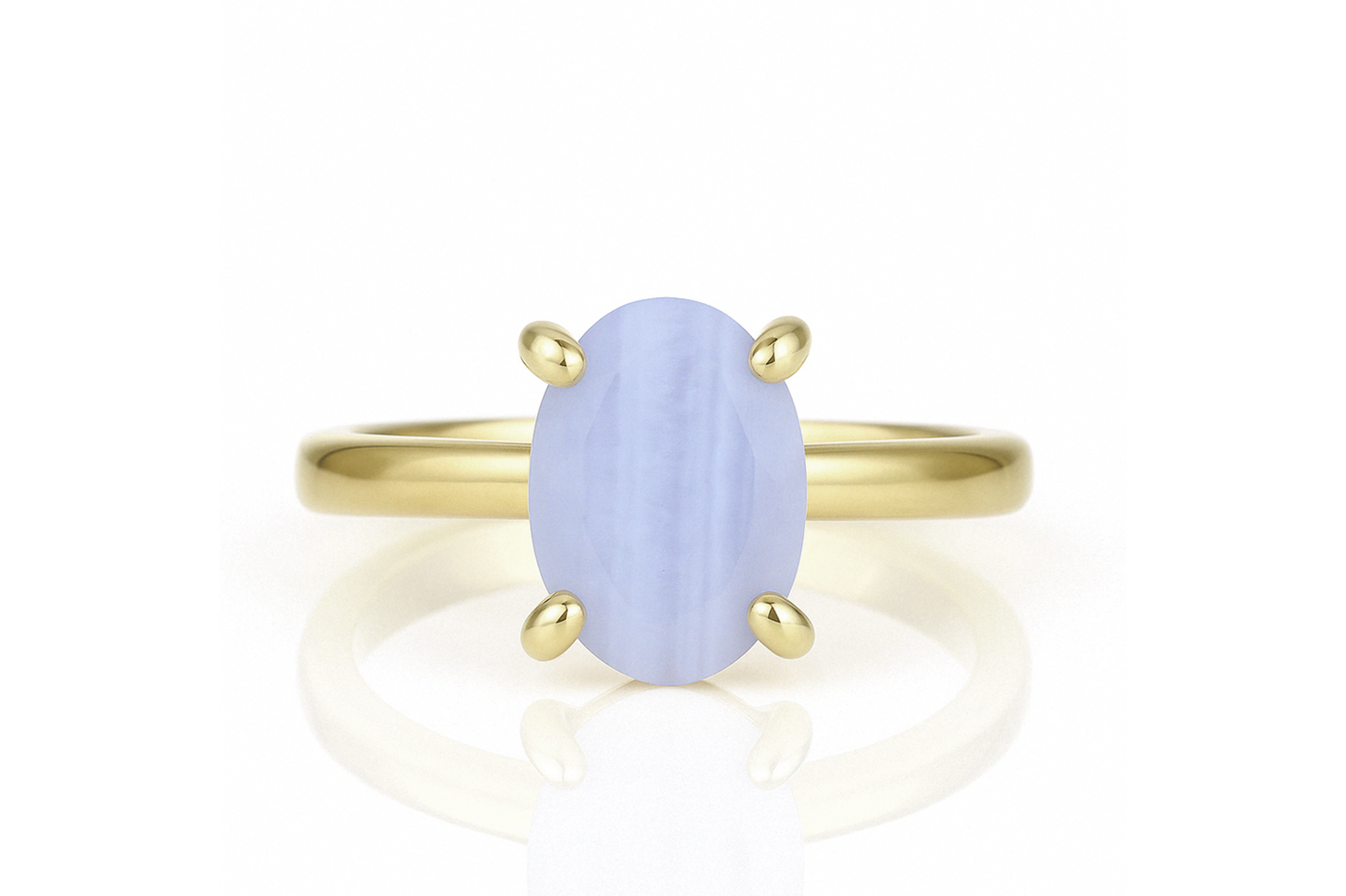 a yellow gold ring with a blue stone