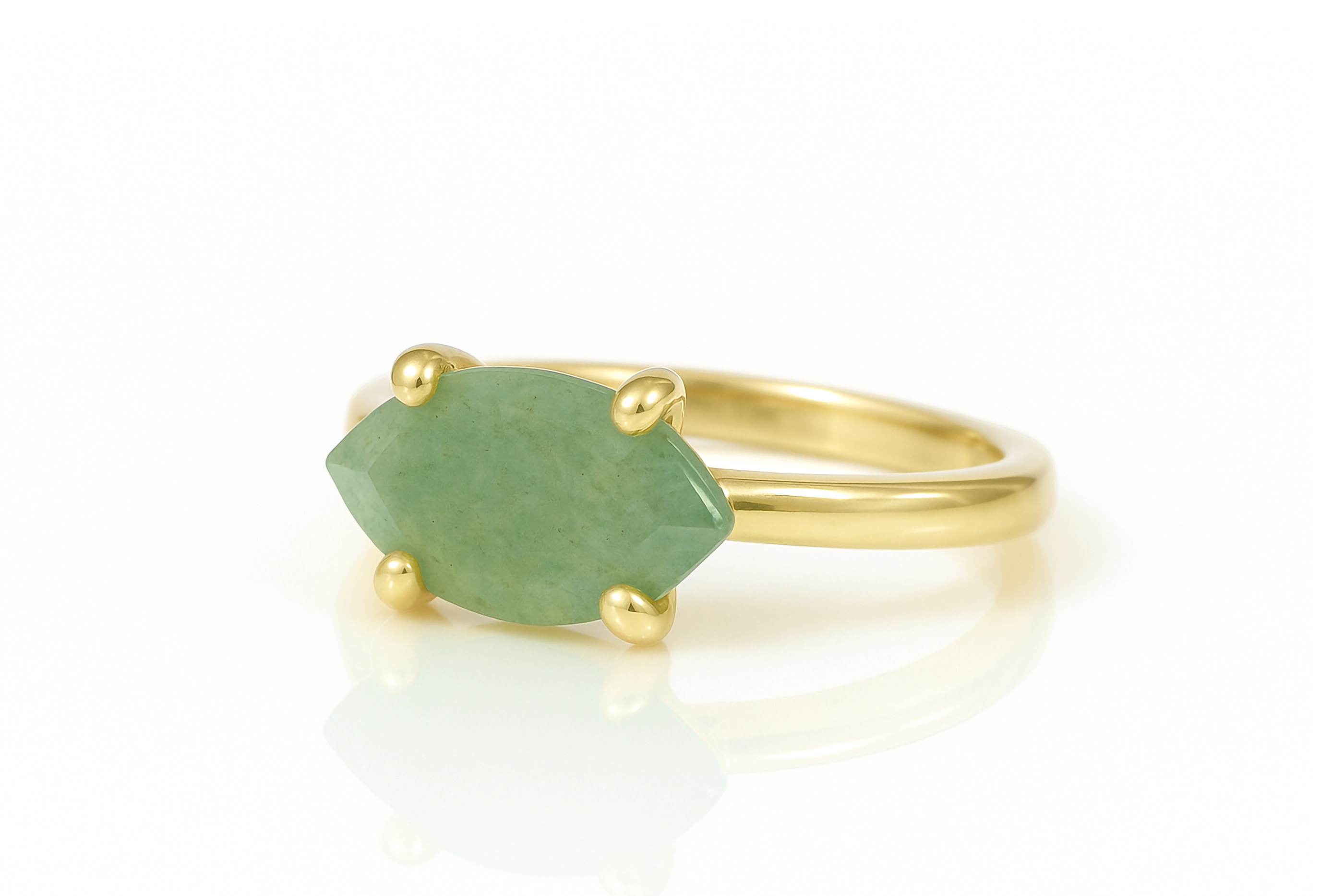 a gold ring with a green stone on it