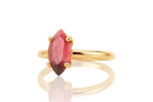 a yellow gold ring with a red stone