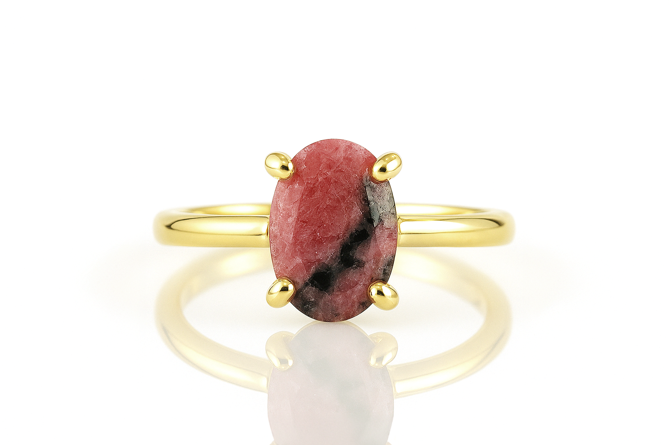 a gold ring with a red stone on it
