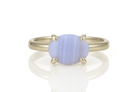 a yellow gold ring with a blue stone