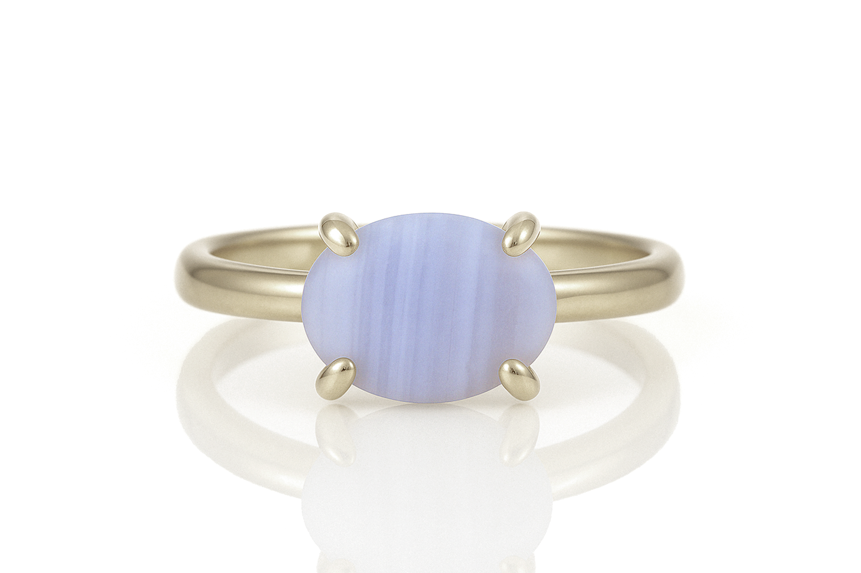 a yellow gold ring with a blue stone
