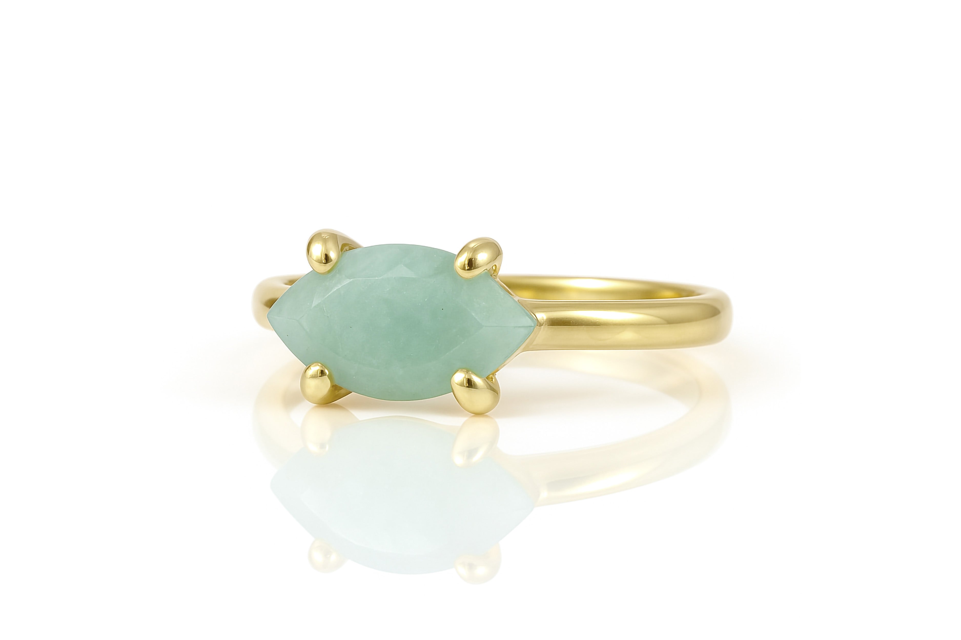 a gold ring with a green stone on it