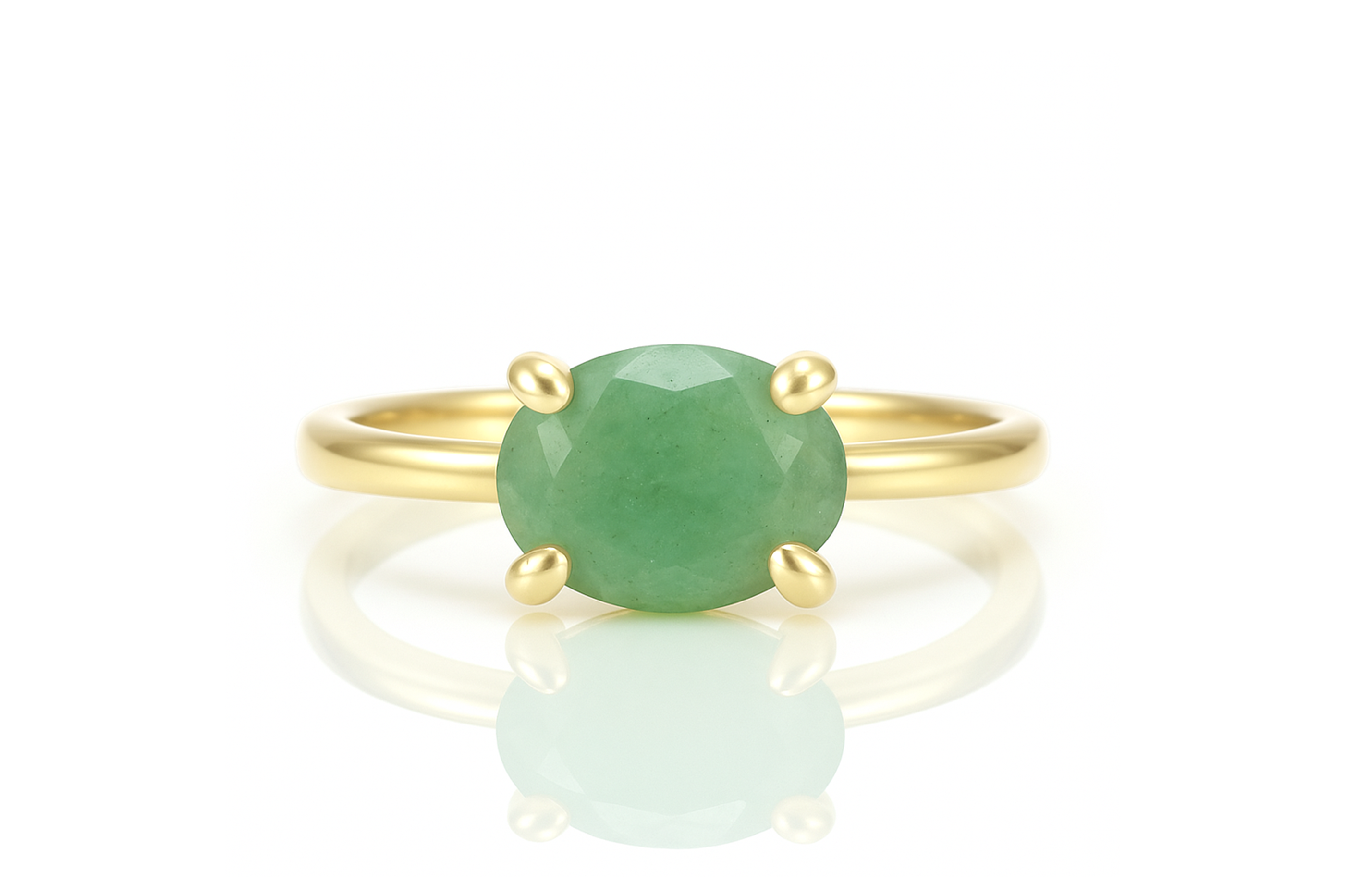 a yellow gold ring with a green stone