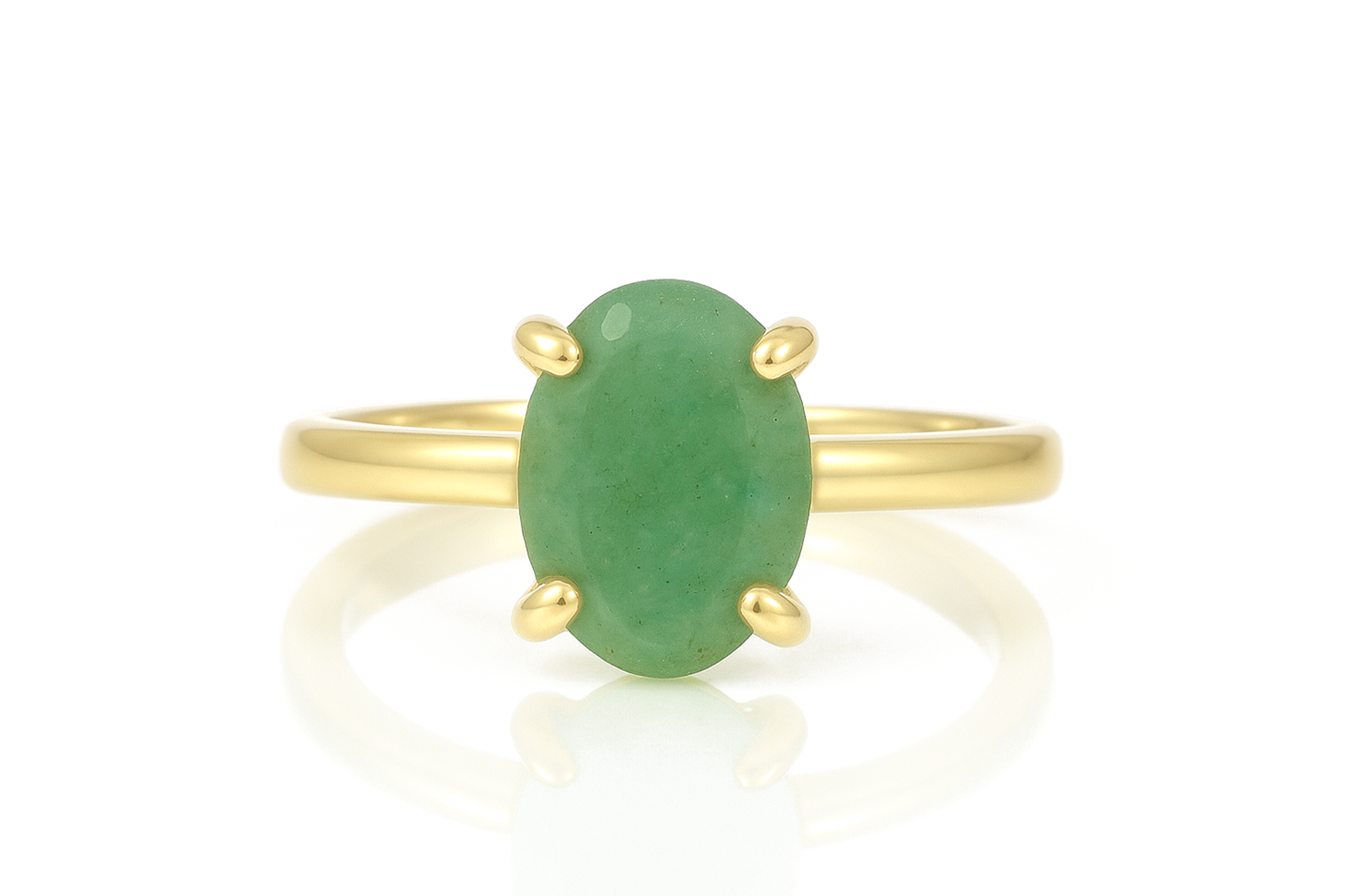 a gold ring with a green jade stone