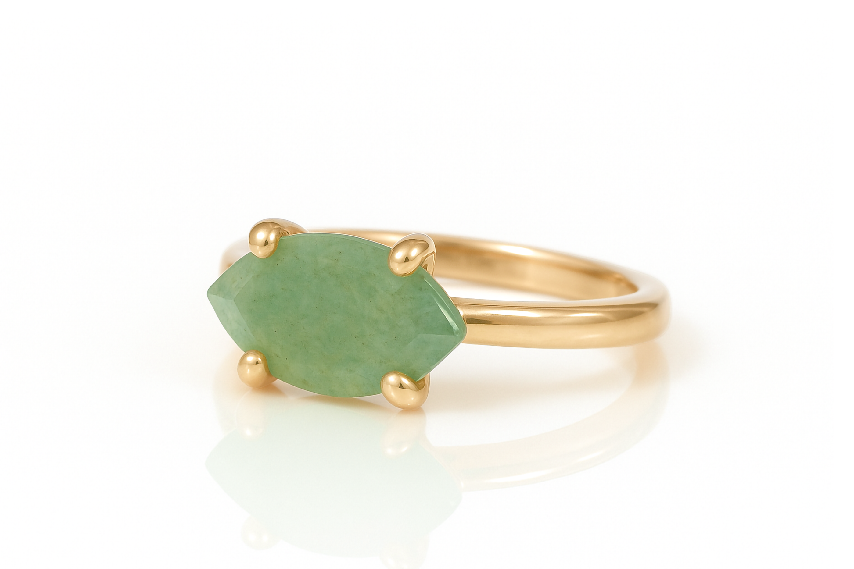 a gold ring with a green stone on it