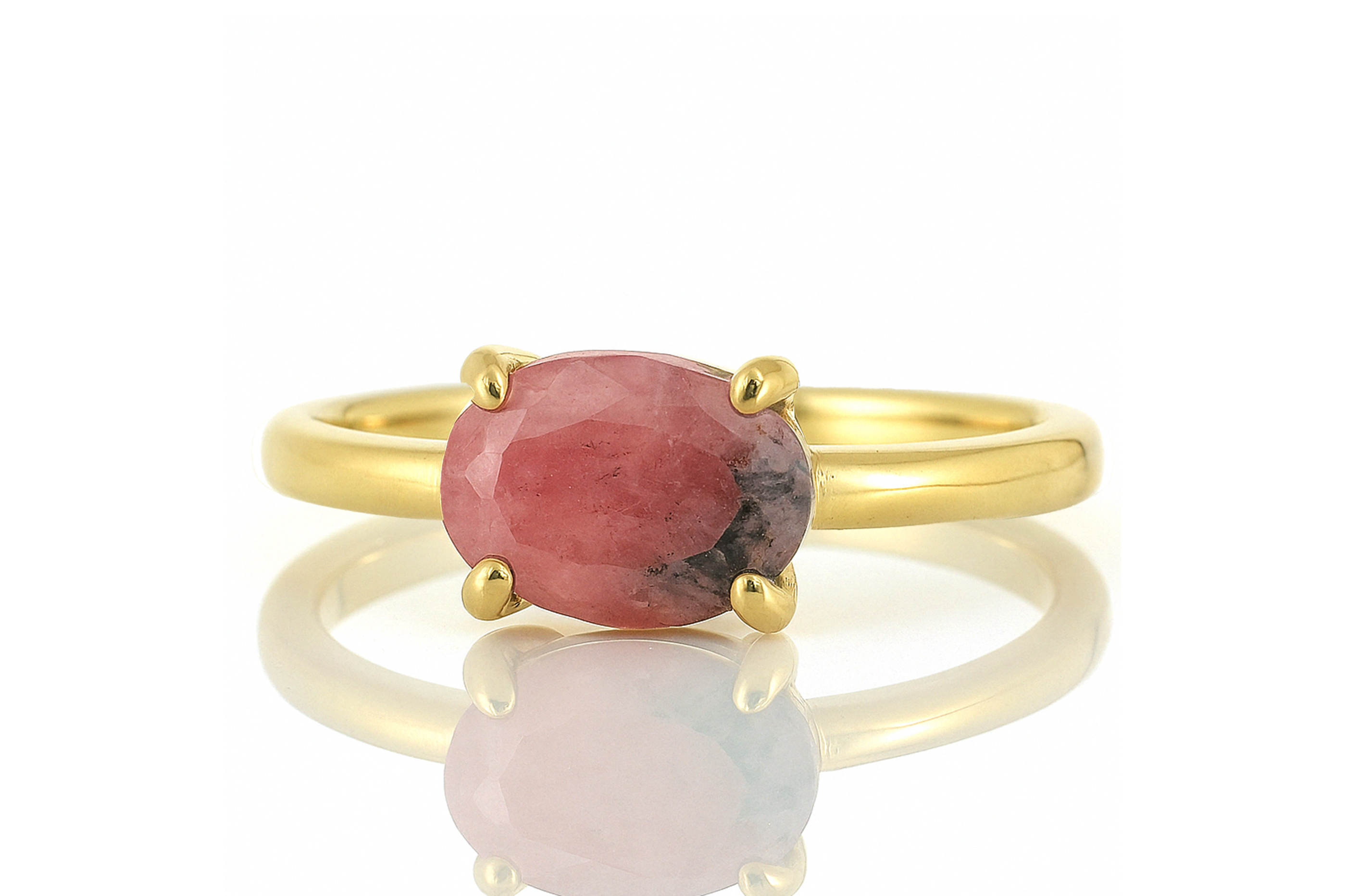 a gold ring with a red stone on it