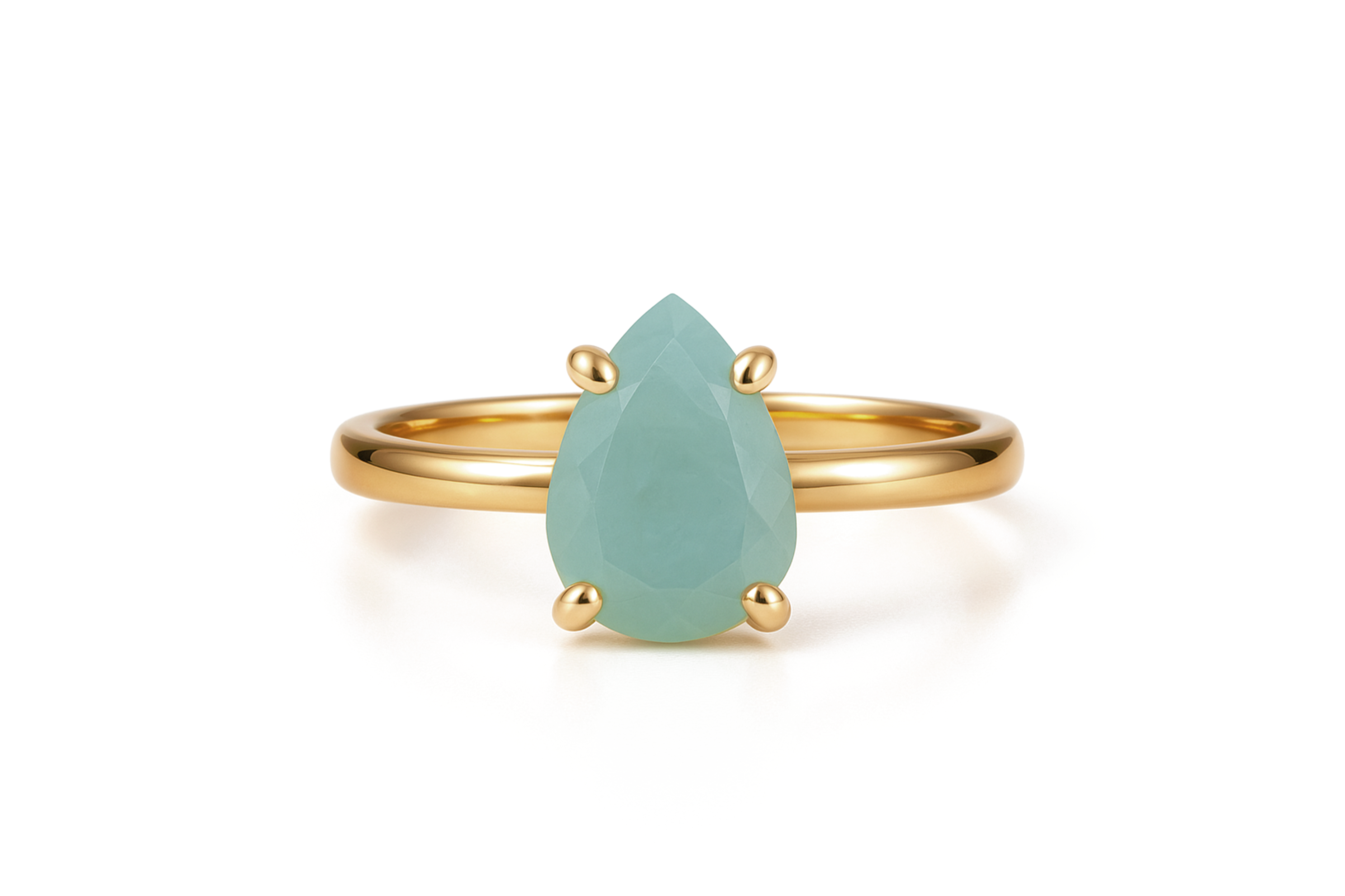 a gold ring with a pear shaped green stone