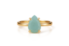 a gold ring with a pear shaped green stone