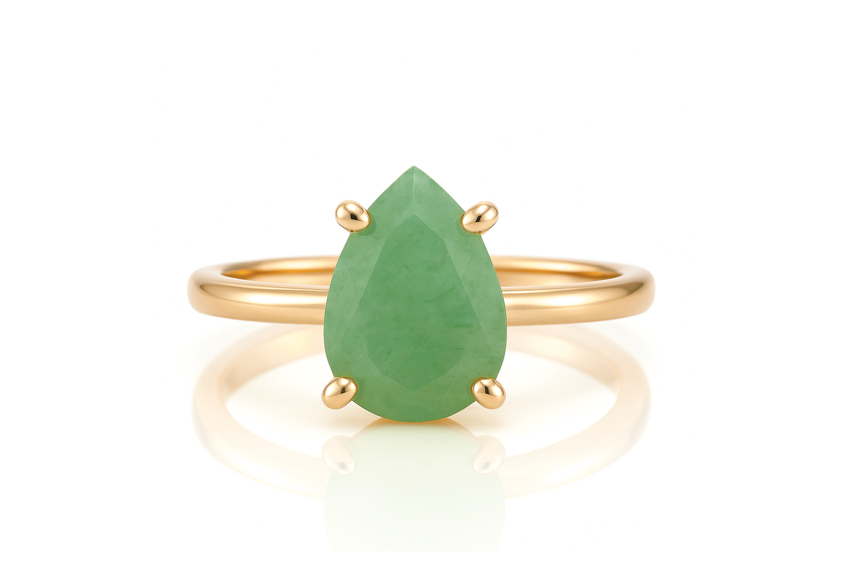 a gold ring with a pear shaped green stone