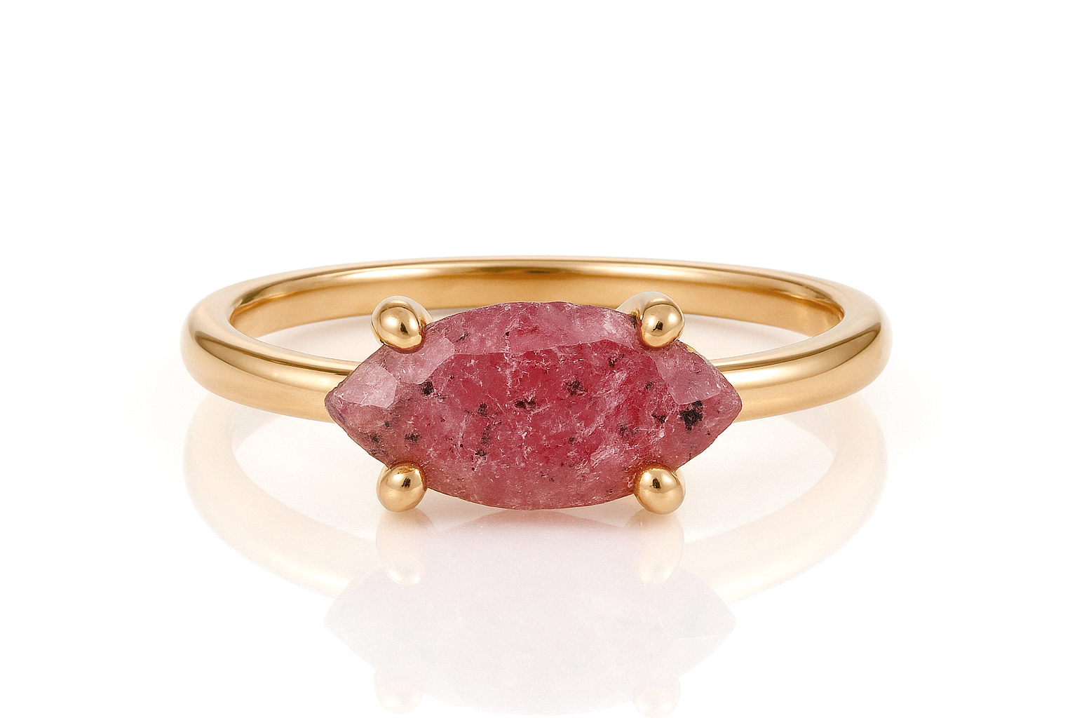 a gold ring with a pink stone on it