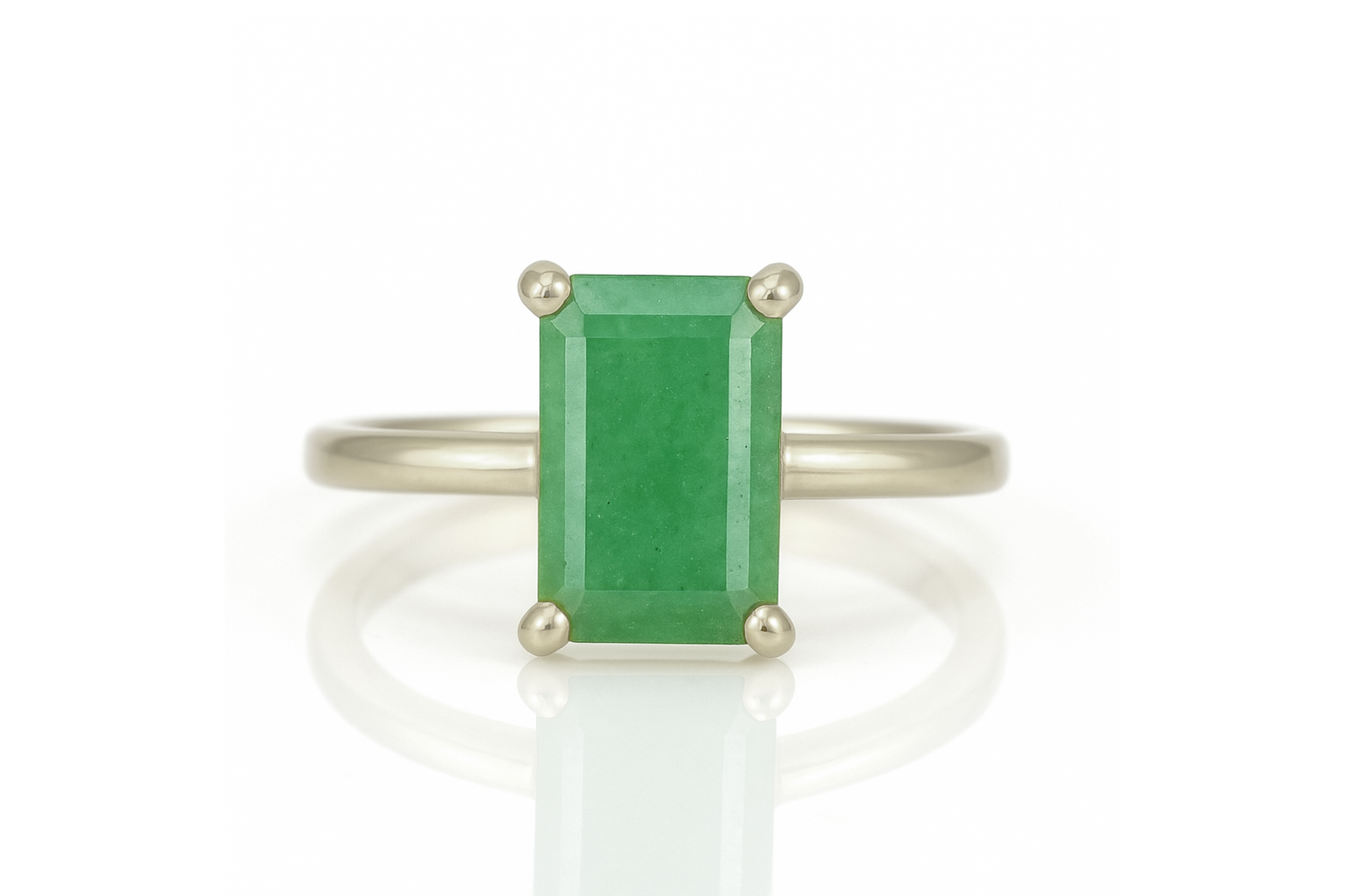 a ring with a green stone on top of it