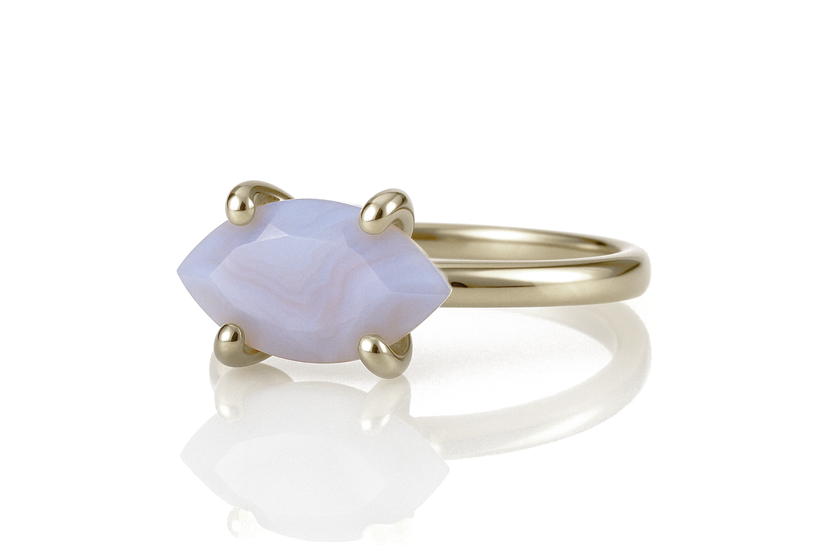 a gold ring with a pink stone in the middle